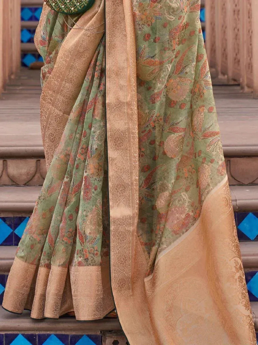 Green and gold designer saree with paisley print and woven border, ideal for ethnic occasions