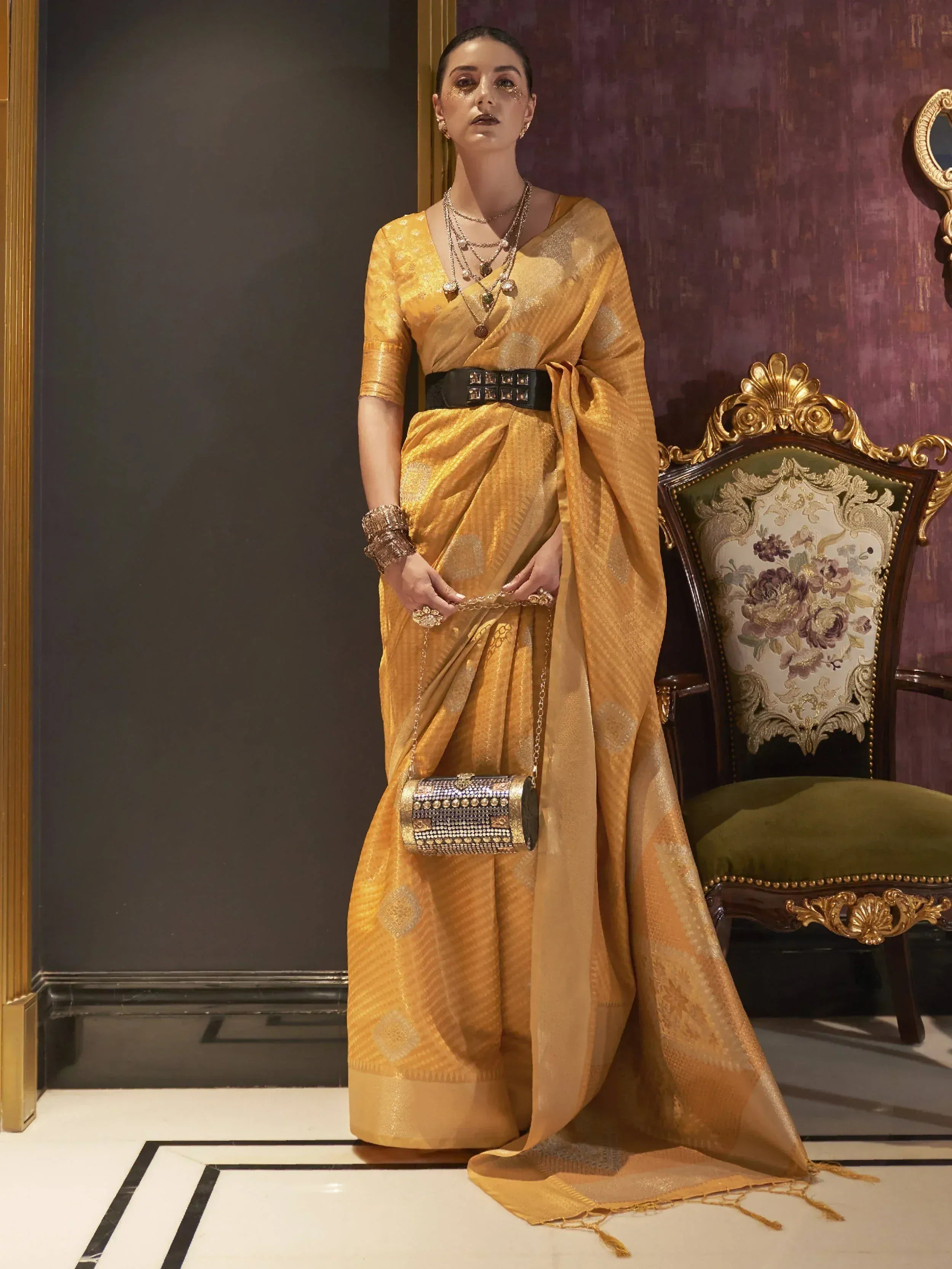 Golden designer saree with black belt, perfect for Indian ethnic wear and festive occasions.