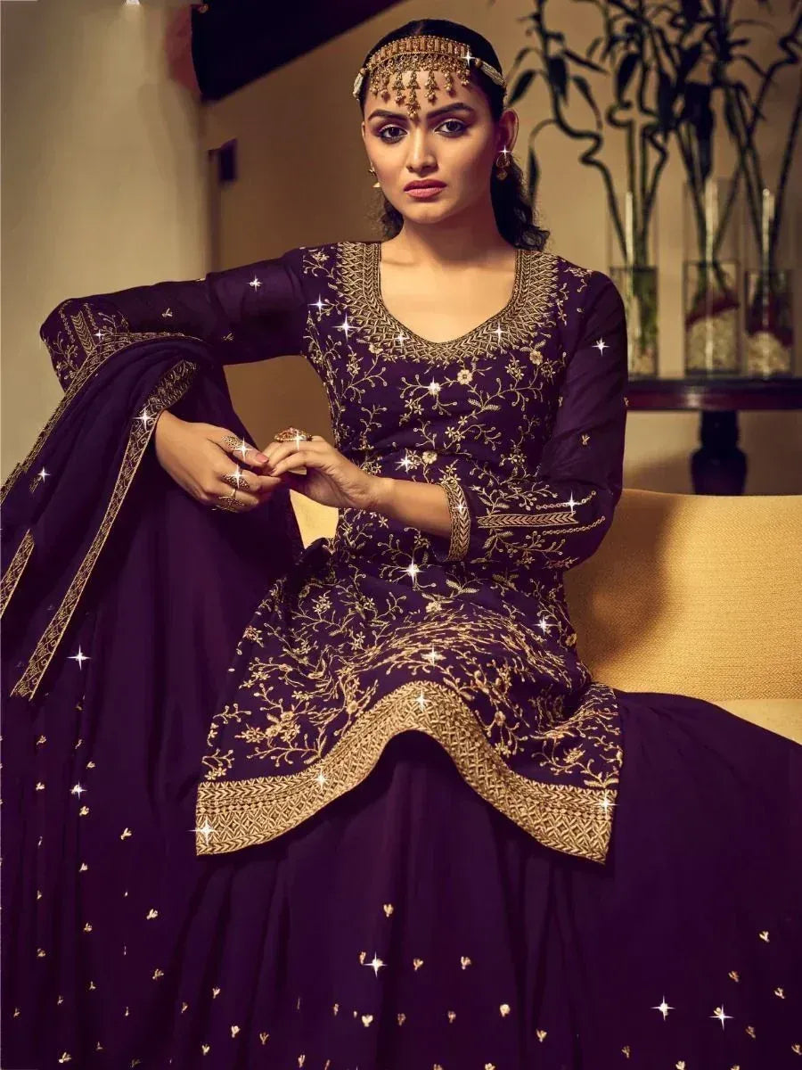 Elegant purple ethnic gown with gold embroidery, perfect for Indian weddings and festive occasions.