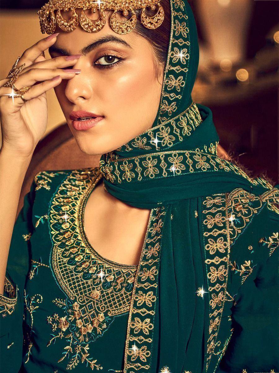 Emerald green embroidered salwar kameez with gold detailing and matching dupatta, perfect for Indian ethnic occasions.