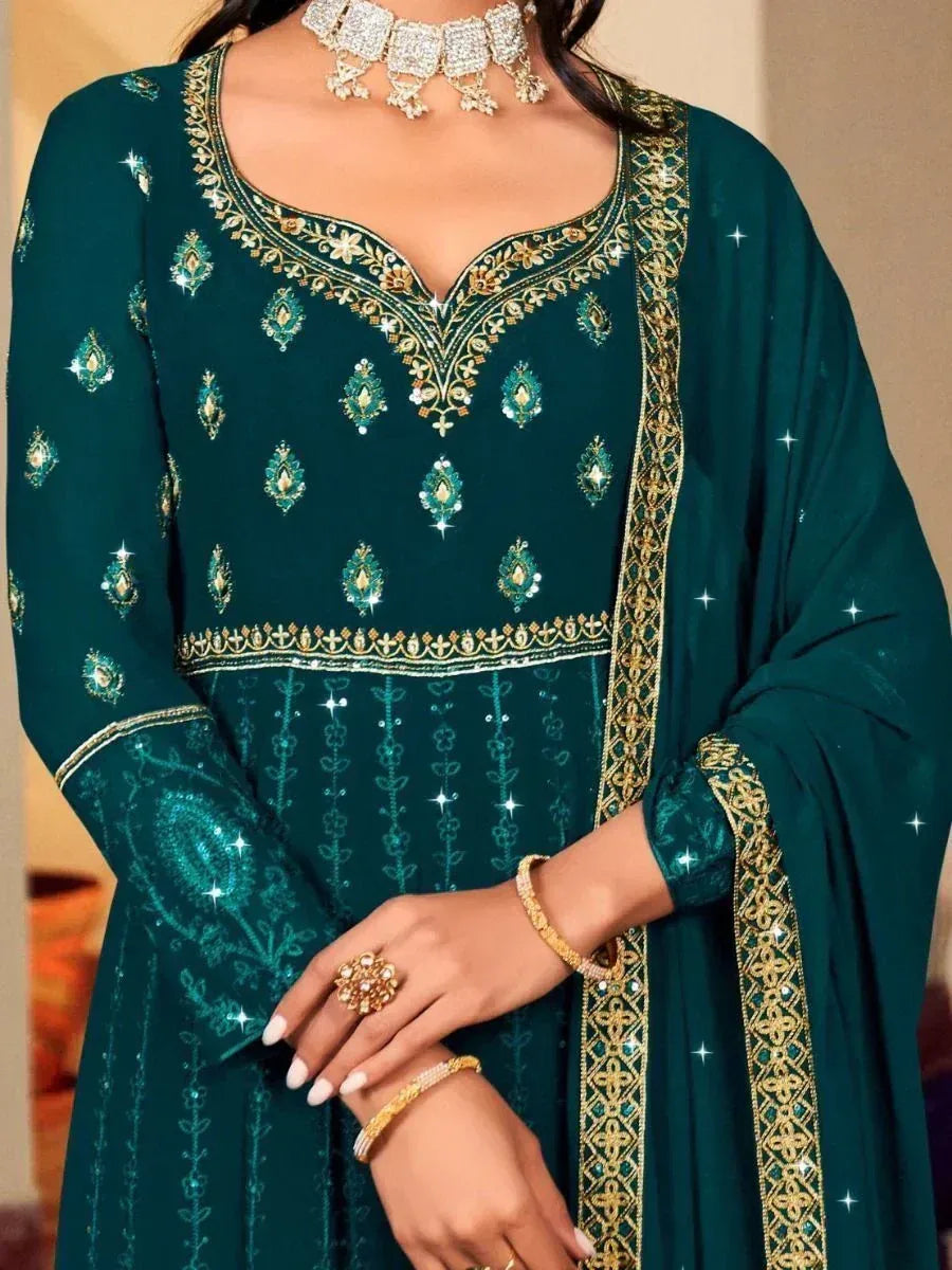 Emerald green designer salwar kameez with gold embroidery and embellished neckline, perfect for ethnic occasions.
