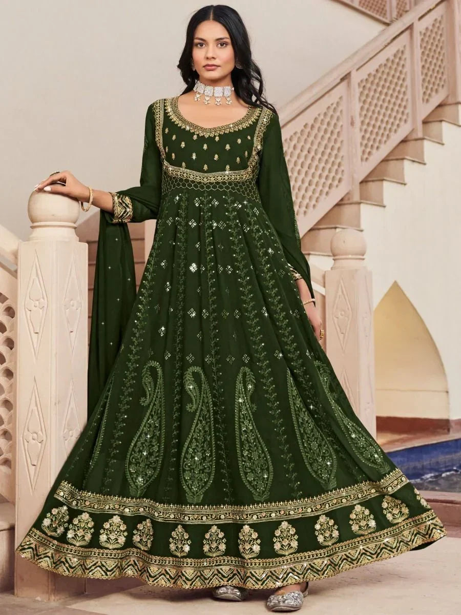 Woman in dark green embroidered Anarkali suit with gold detailing, traditional Indian ethnic wear