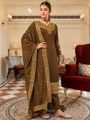 Woman wearing embroidered brown salwar kameez with dupatta in elegant living room, Ethnic Plus