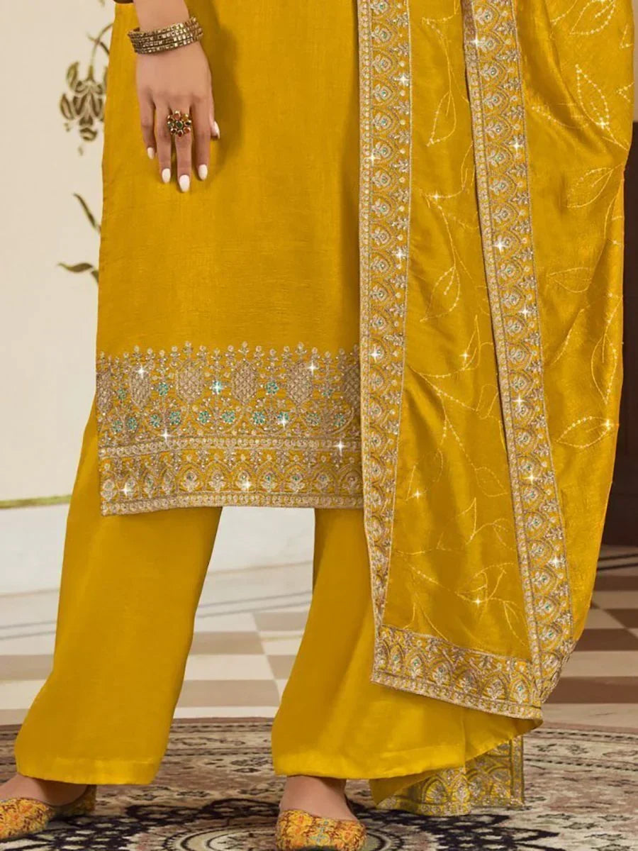 Mustard yellow salwar kameez with intricate embroidery and matching dupatta