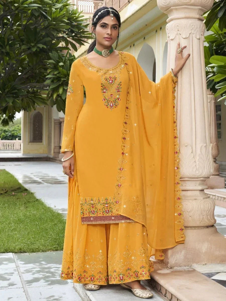 Woman in yellow embroidered salwar kameez with dupatta, traditional Indian ethnic wear