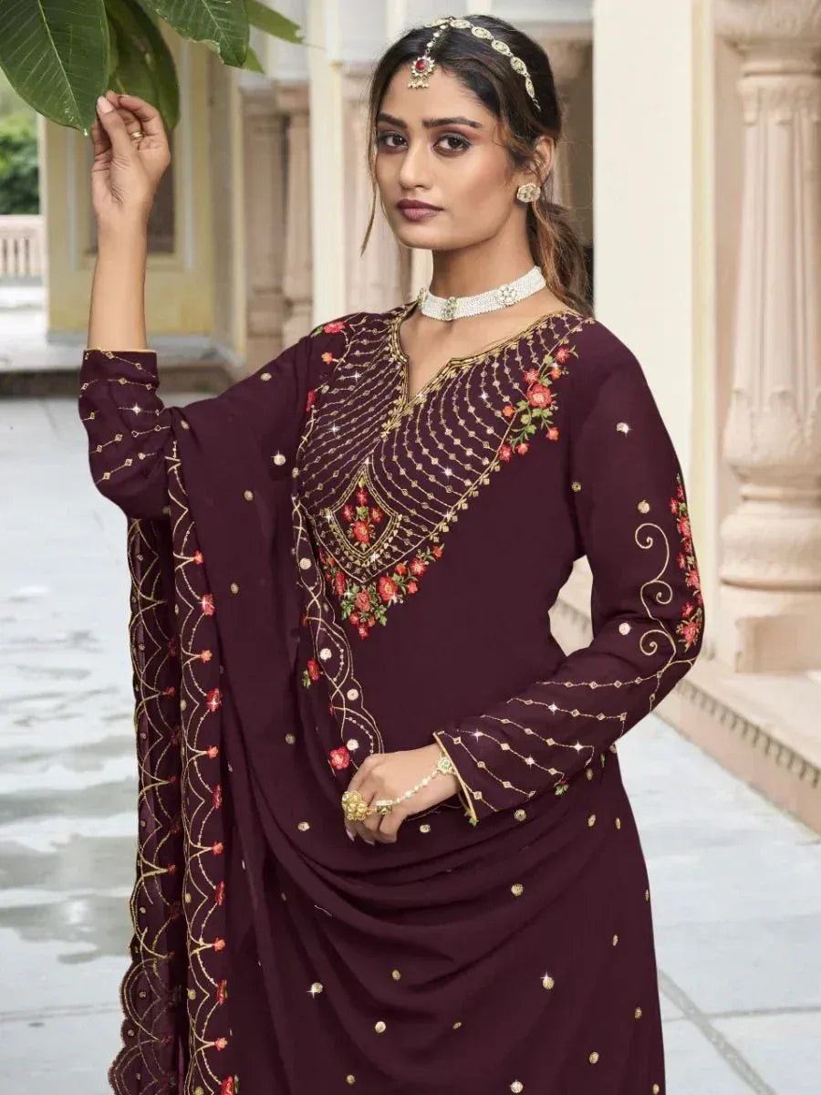 Woman in maroon salwar kameez with gold and floral embroidery, traditional Indian ethnic wear