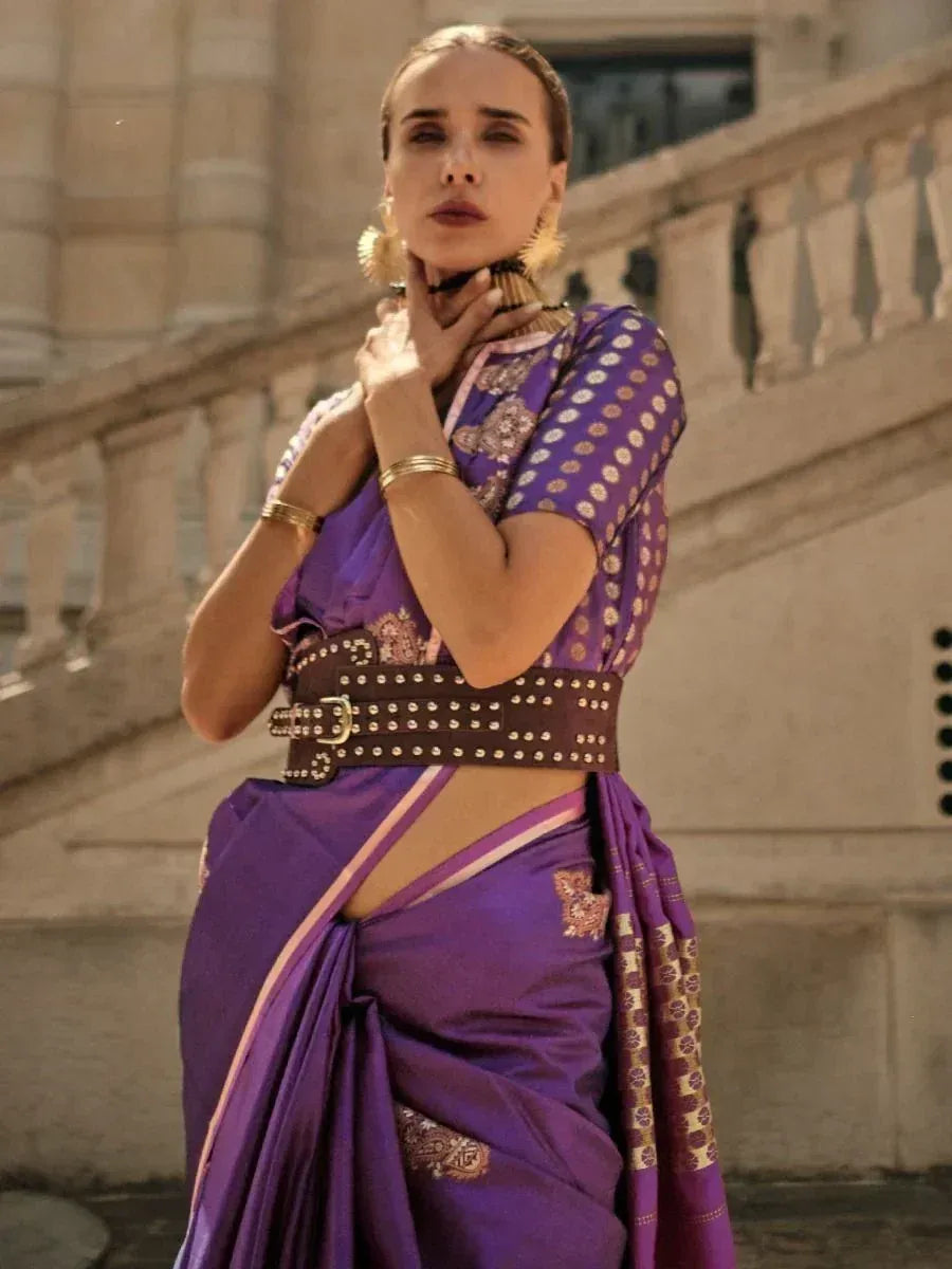 Purple designer saree with gold embroidery, studded belt, and statement earrings for ethnic wear