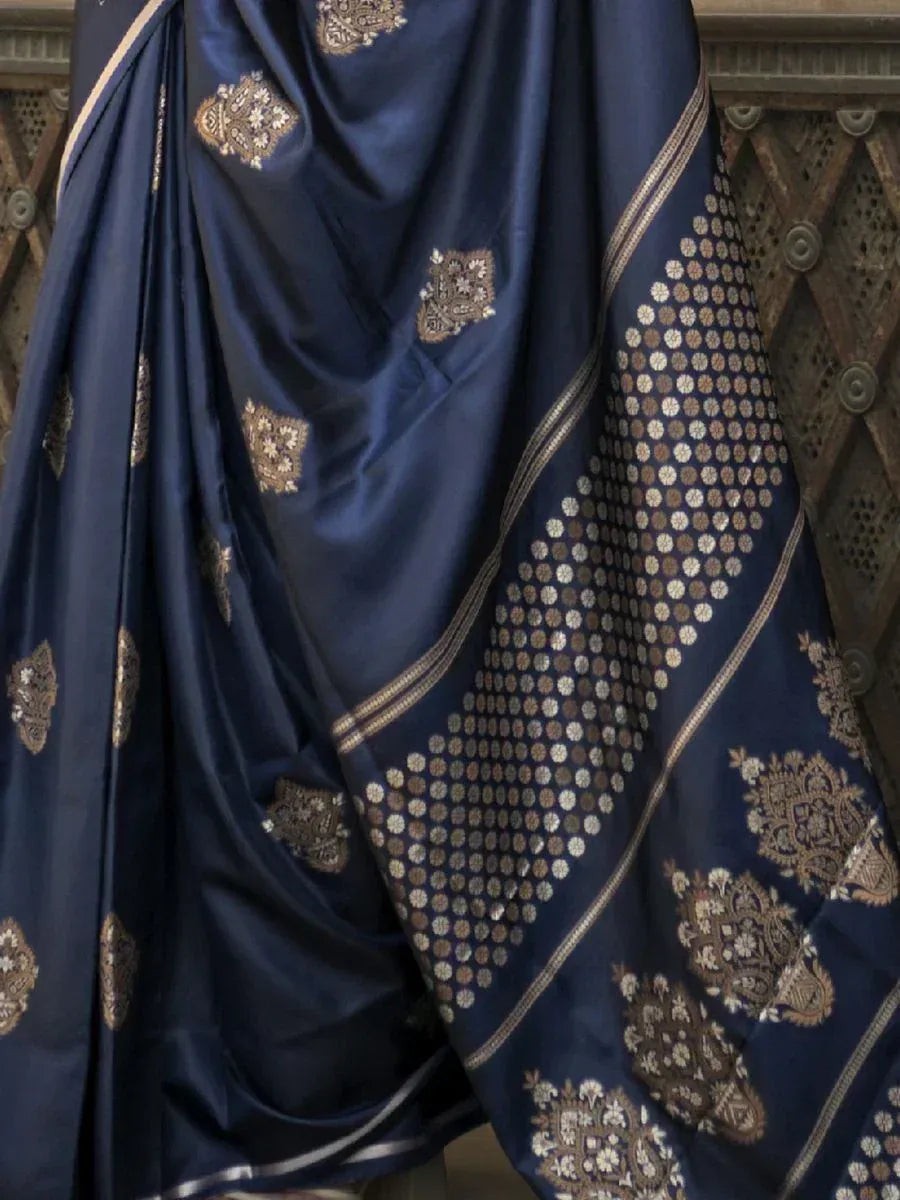 Navy blue designer saree with gold embroidery and circular motifs, ideal for ethnic occasions.
