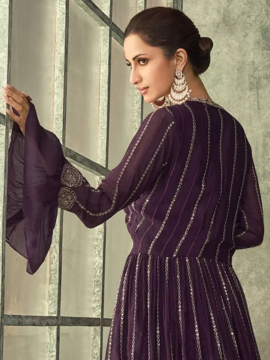 Purple ethnic gown with silver chain embroidery, bell sleeves, and traditional jewelry for Indian wear