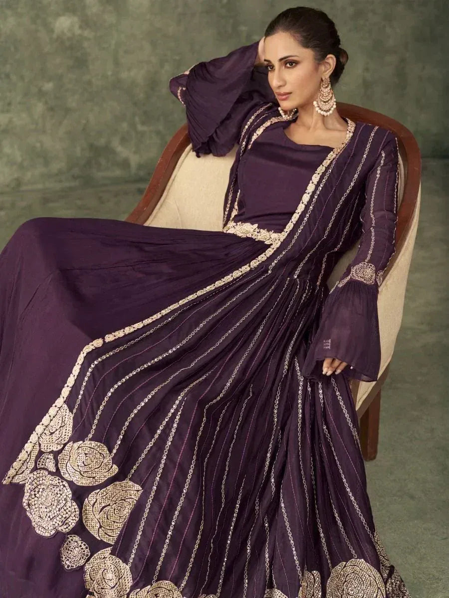 Elegant purple ethnic gown with gold floral embroidery, perfect for Indian weddings and festive occasions.