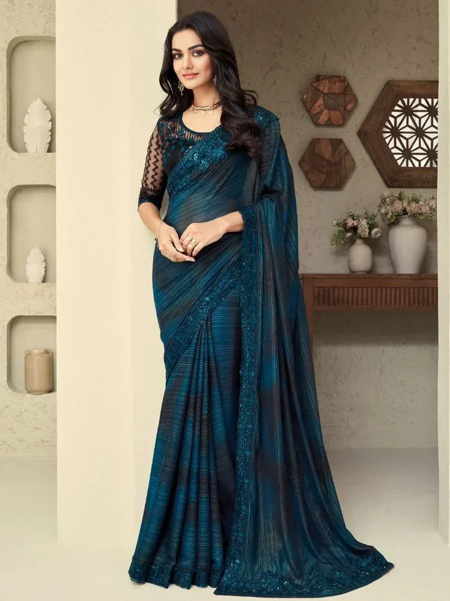 Elegant teal designer saree with sequin border and sheer blouse, perfect for Indian ethnic occasions