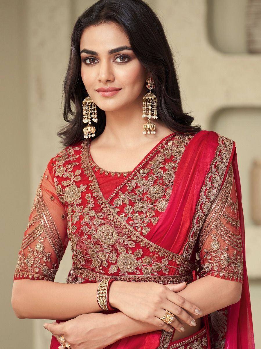 Red embroidered ethnic saree with gold floral work and jhumka earrings for Indian occasions