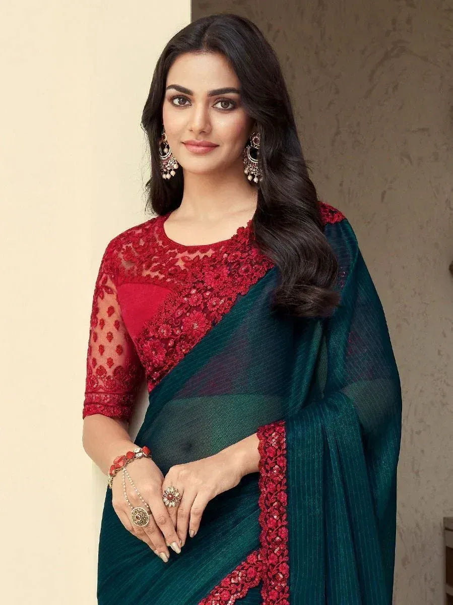 Elegant teal saree with red lace blouse, perfect for Indian ethnic wear and festive occasions.