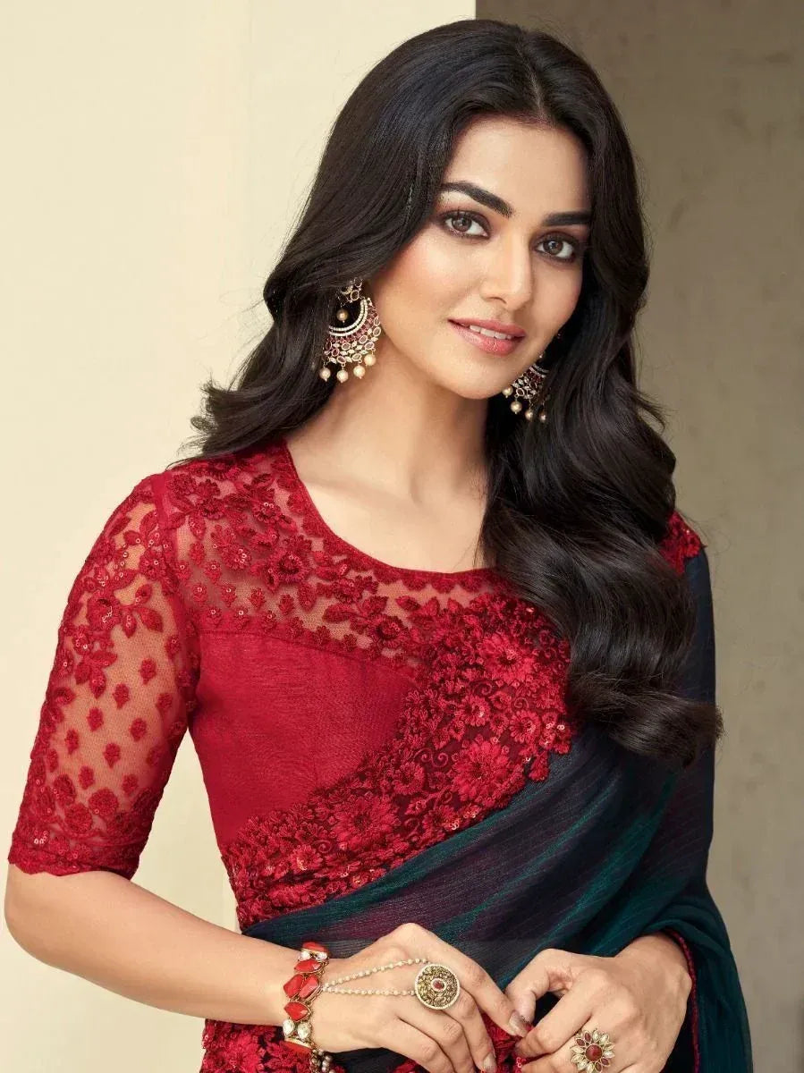 Woman in red lace blouse with dark green saree, traditional Indian ethnic wear, designer jewelry
