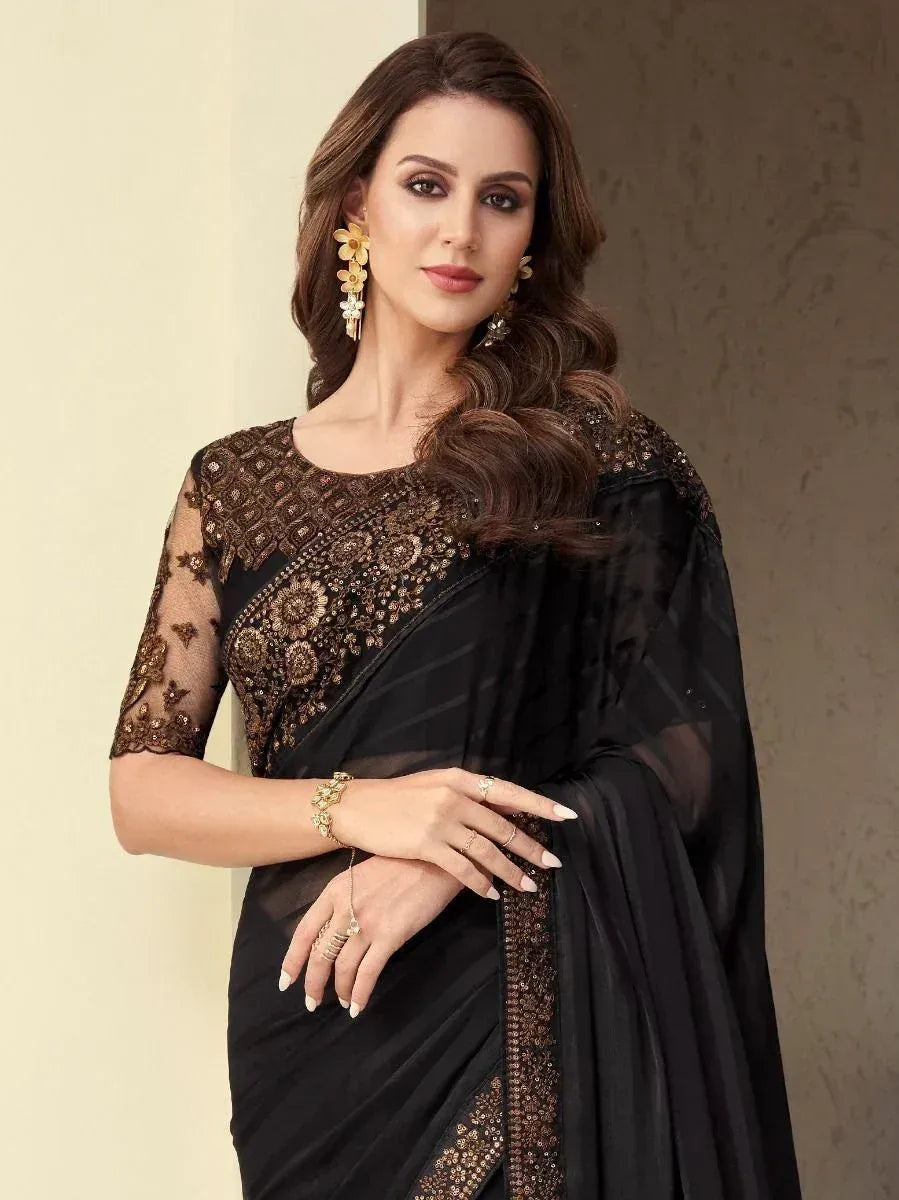 Elegant black saree with gold embroidery, sheer sleeves, and designer blouse for Indian ethnic wear