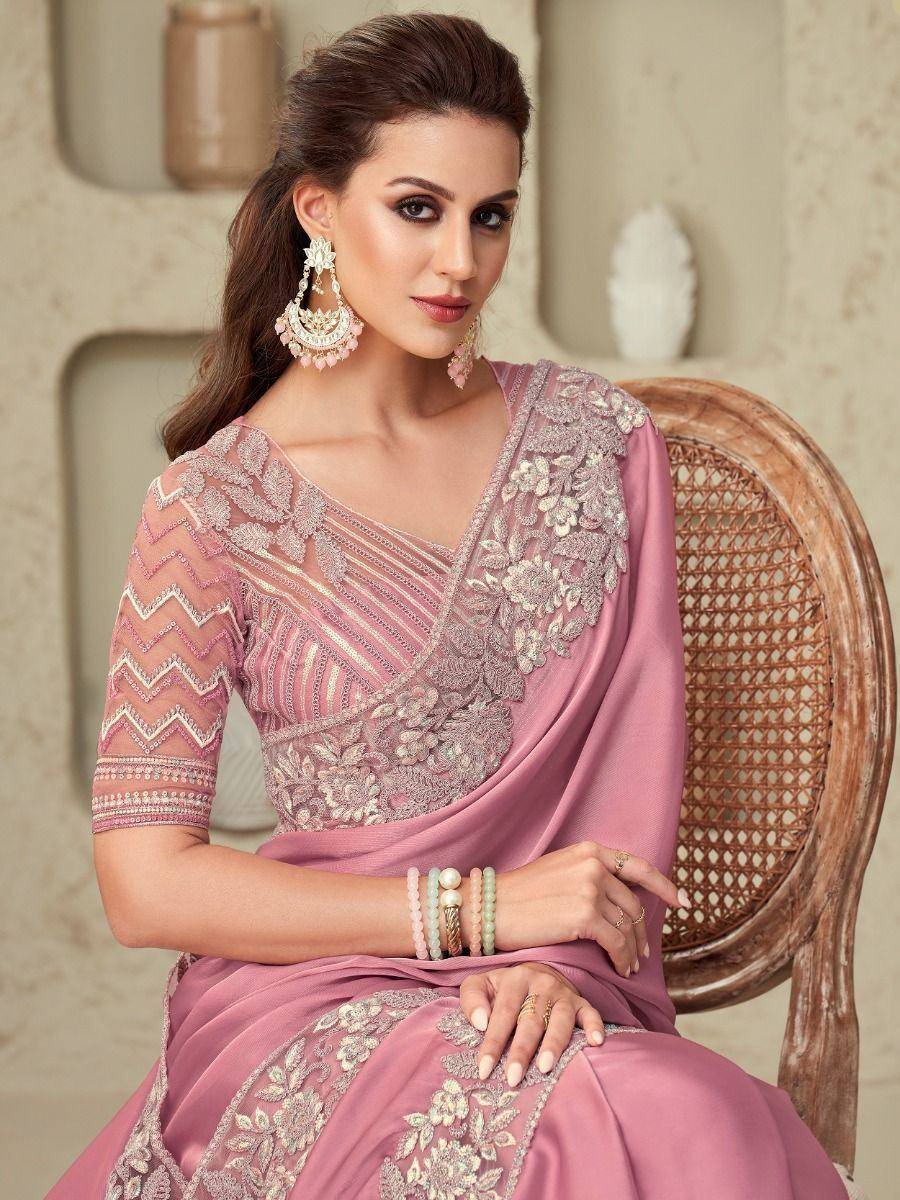 Elegant pink embroidered saree with floral detailing and stylish jewelry for ethnic occasions