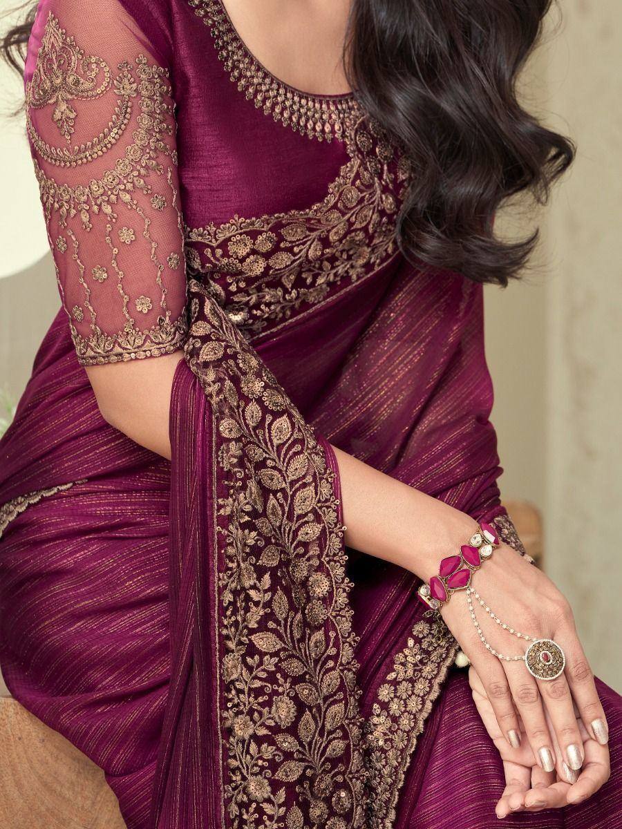 Elegant maroon saree with gold embroidery, sheer sleeves, and traditional Indian jewelry for festive occasions