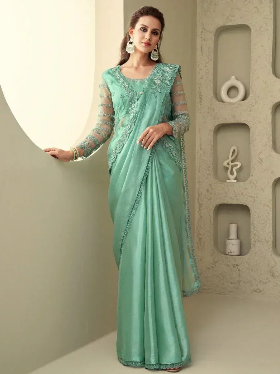 Mint green designer saree with lace detailing, perfect for ethnic occasions and festive wear.