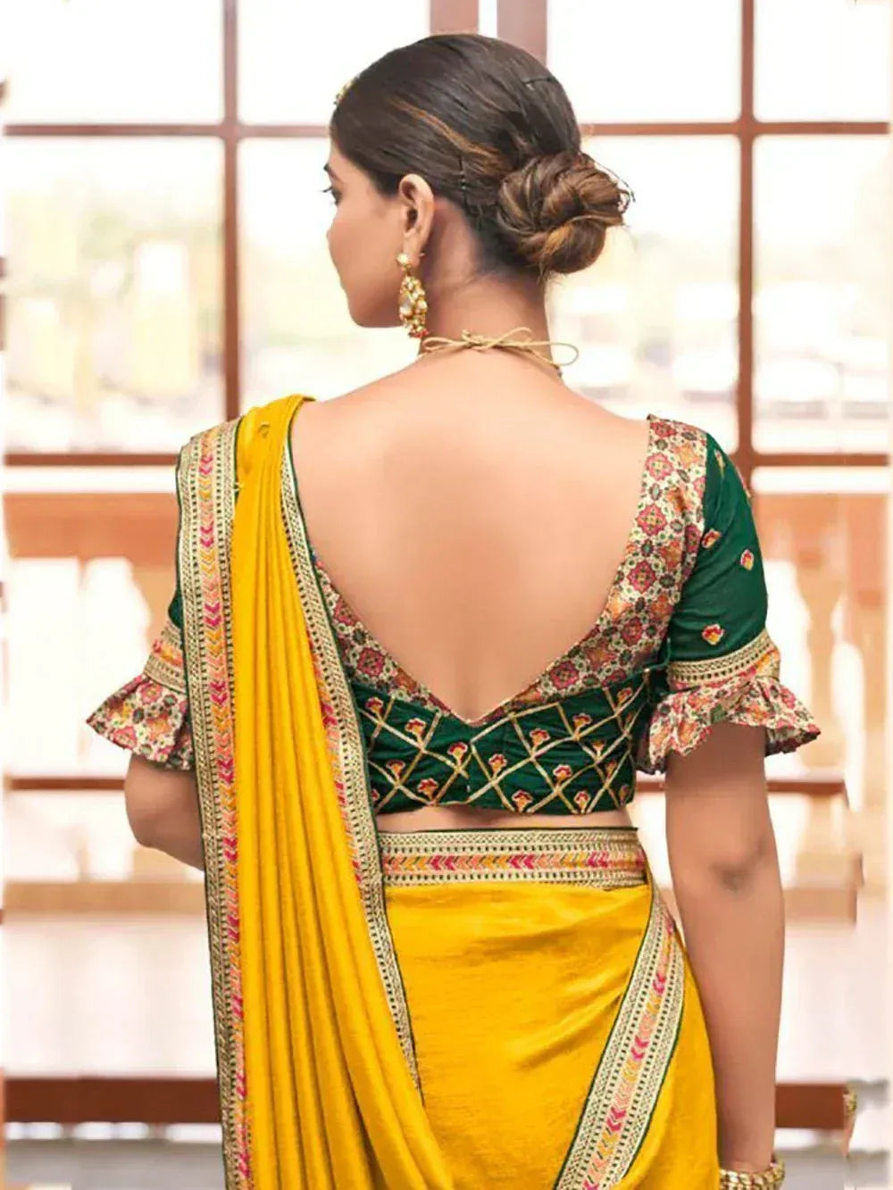 Yellow saree with green embroidered blouse, backless design, floral patterns, ethnic Indian wear