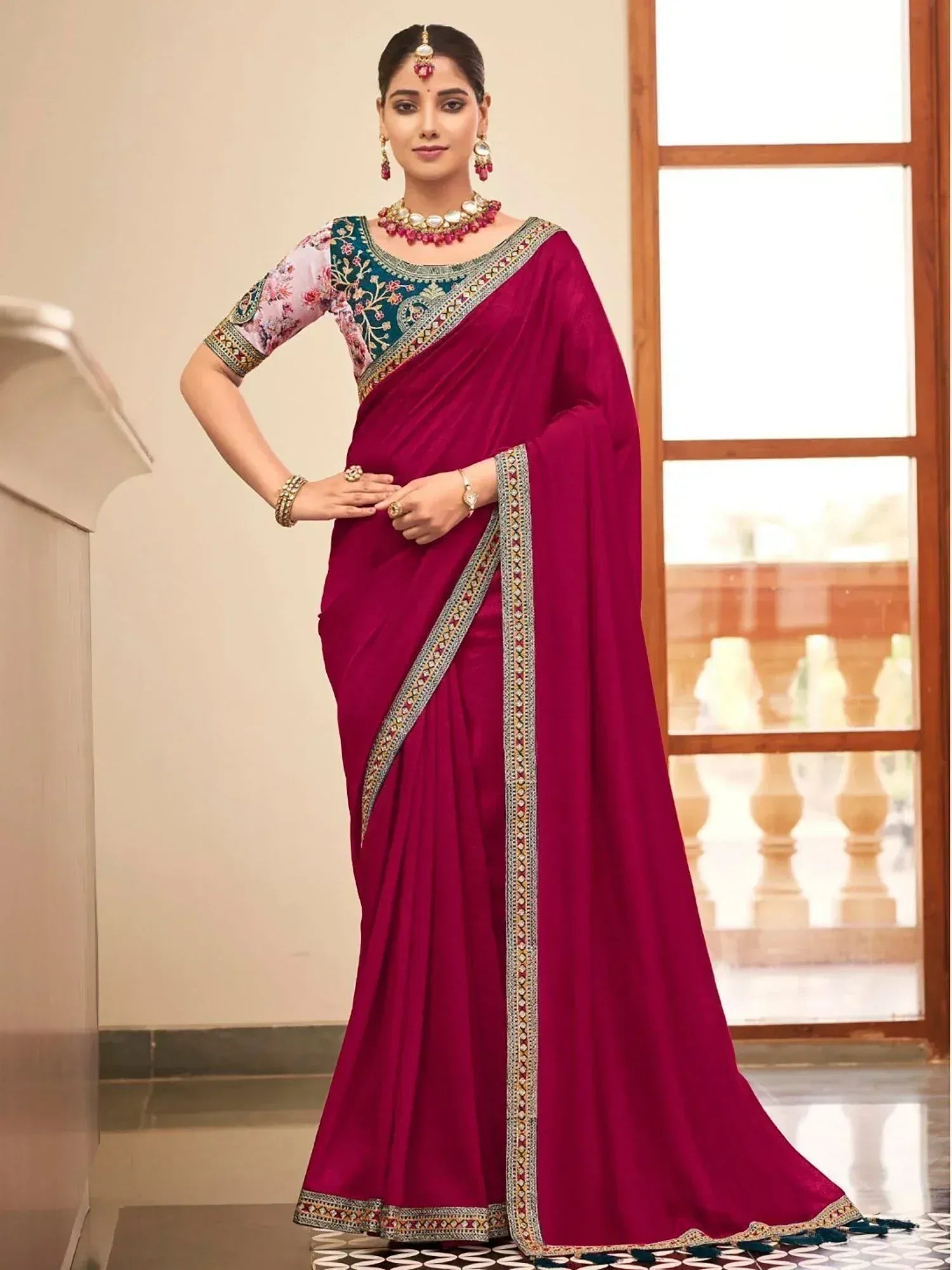 Woman in maroon designer saree with floral blouse and ethnic jewelry, perfect for Indian occasions