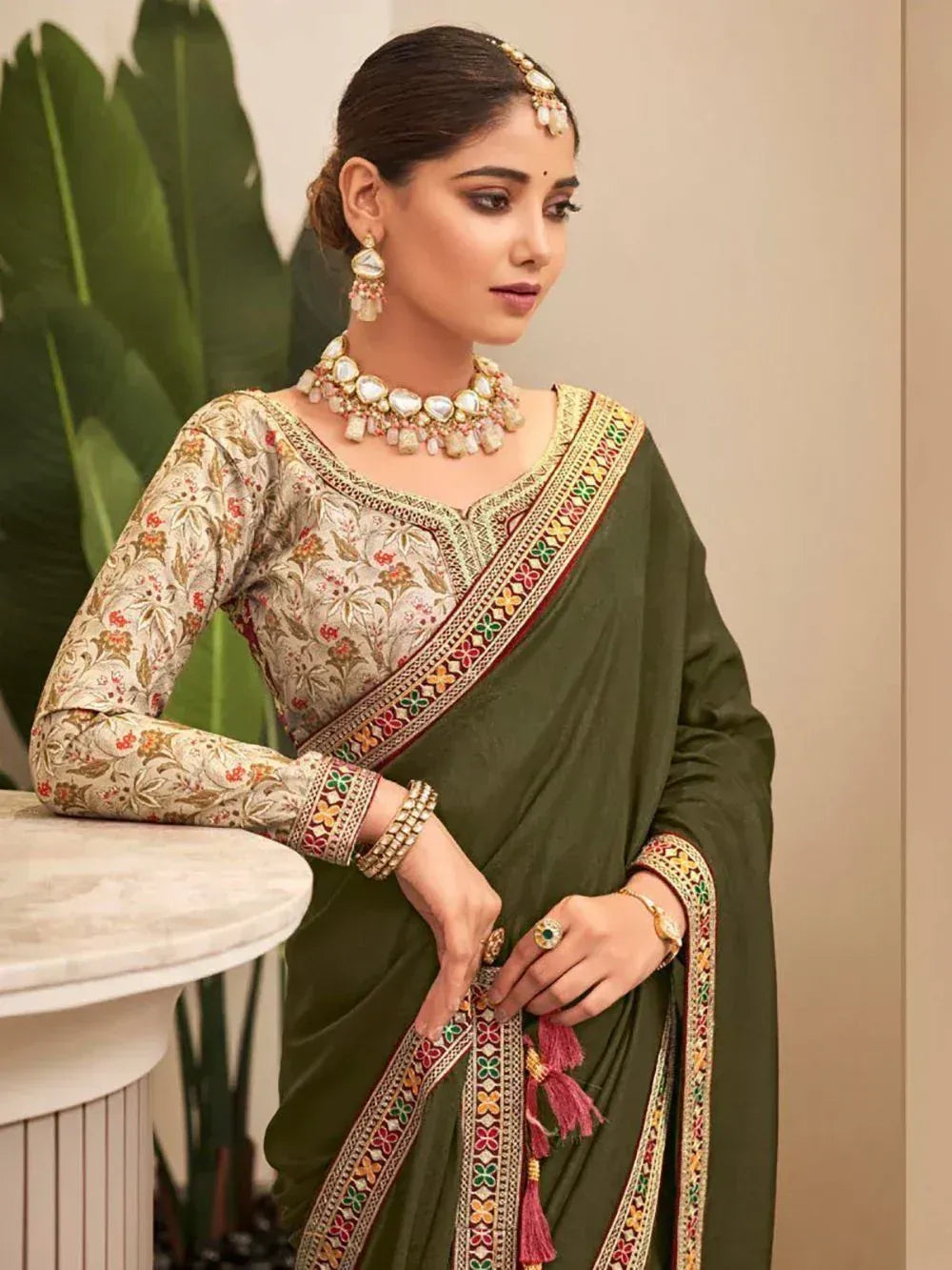 Elegant olive green saree with floral blouse and traditional jewelry for Indian ethnic wear