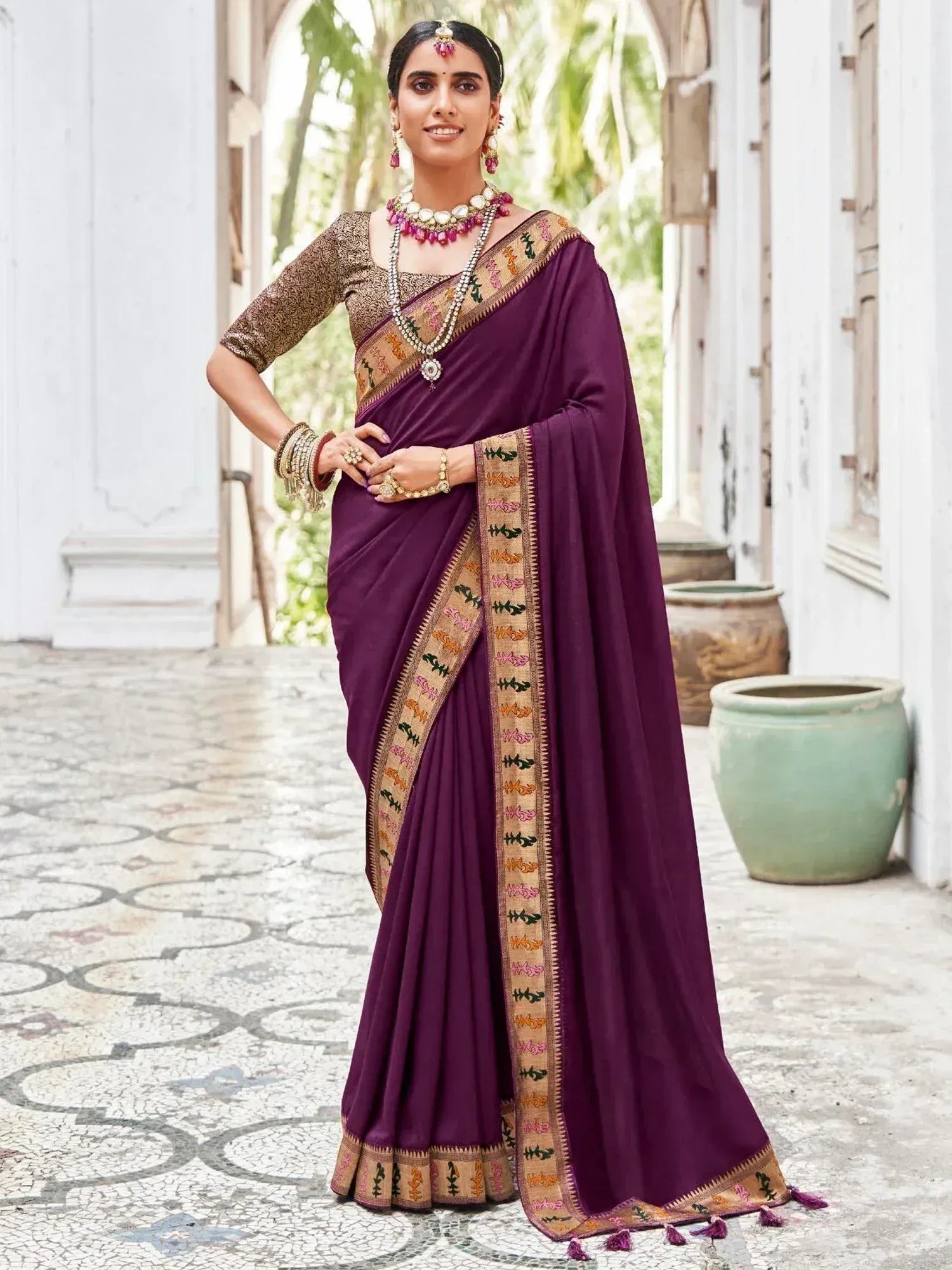 Woman in purple embroidered saree with gold blouse, traditional Indian ethnic wear