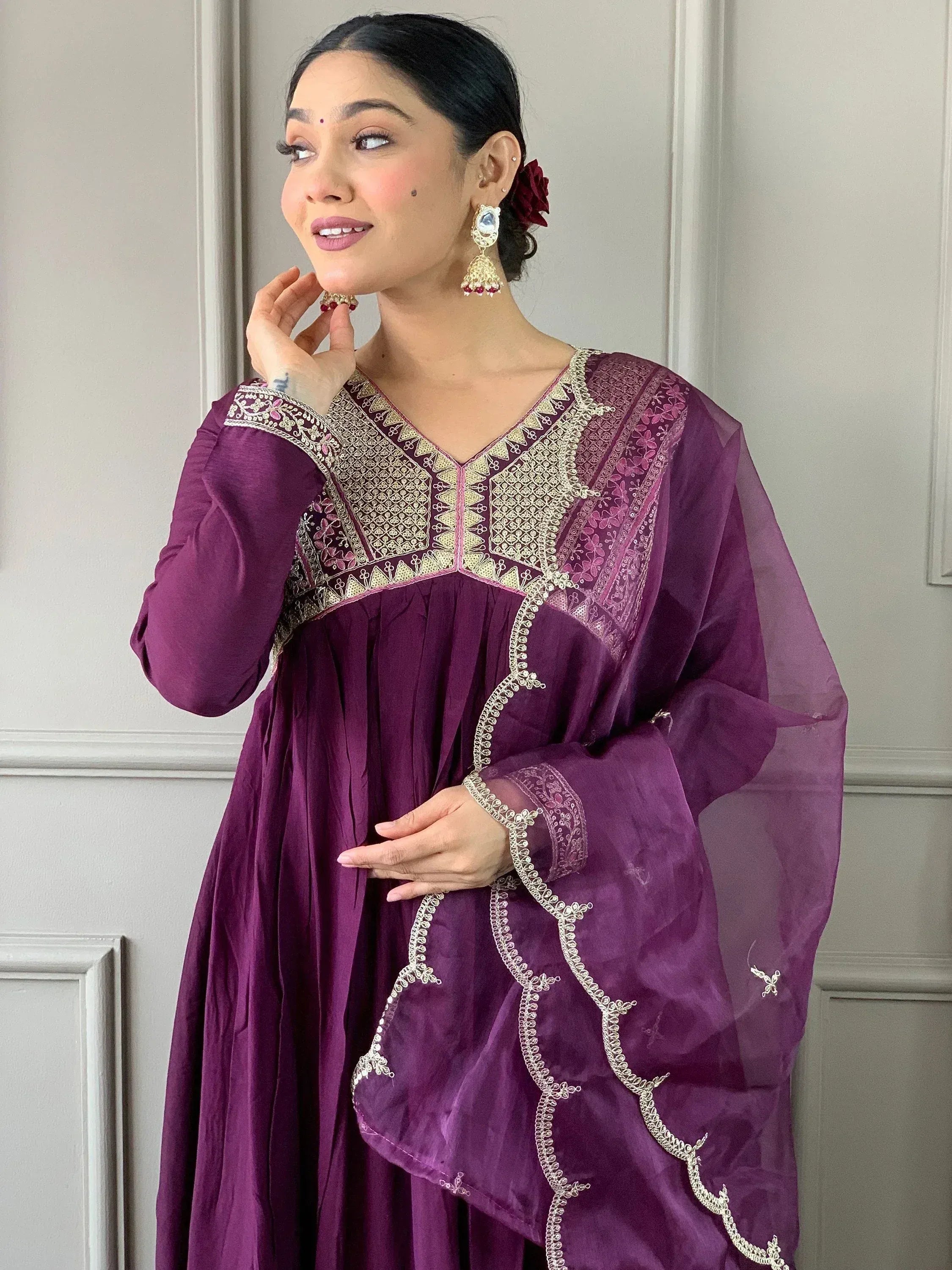 Purple ethnic gown with gold embroidery, perfect for Indian celebrations and festive occasions.