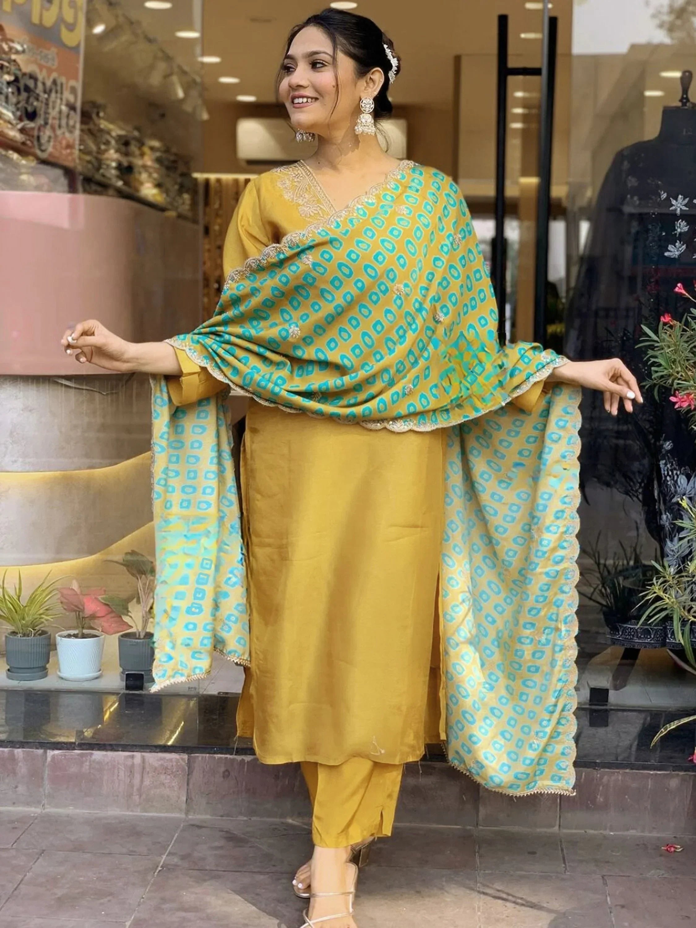 Woman in mustard yellow salwar kameez with blue patterned dupatta, ethnic Indian wear