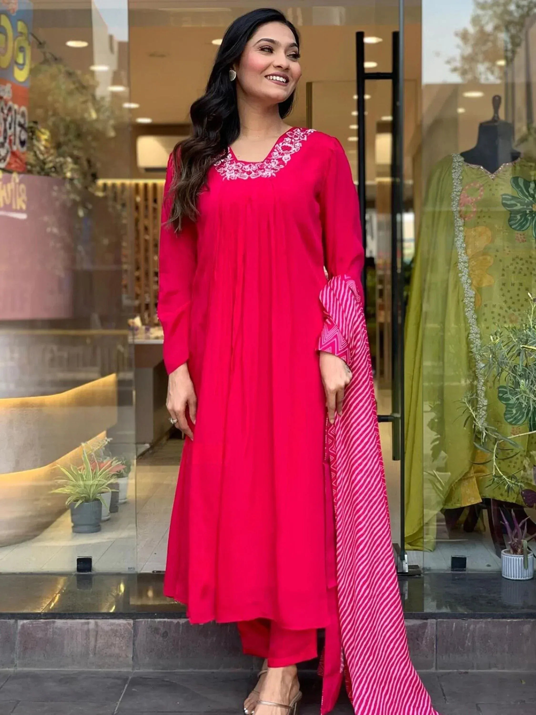 Vibrant pink ethnic kurta with white embroidery, paired with matching palazzo and striped dupatta, perfect for festive occasions.