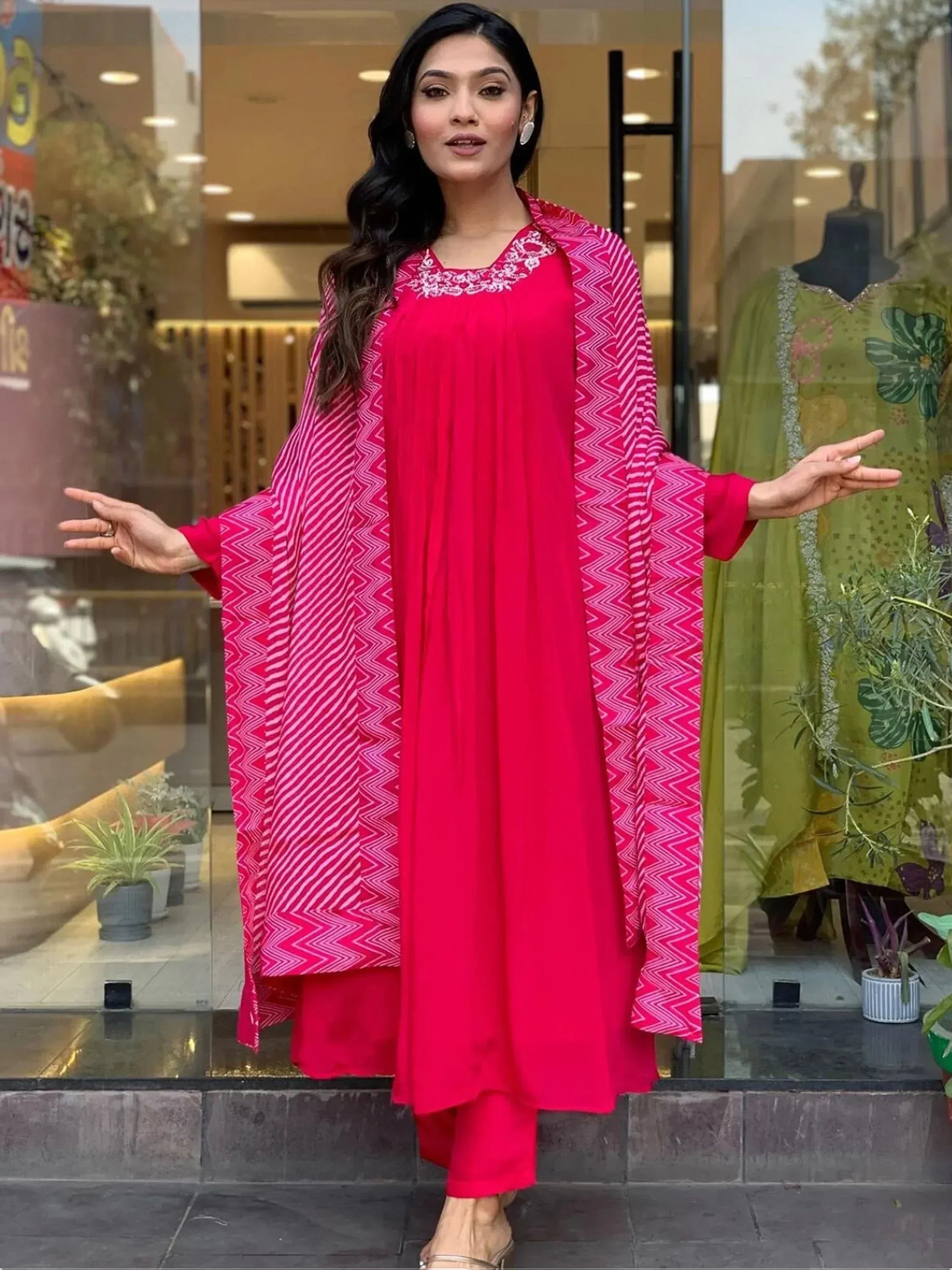 Vibrant pink ethnic salwar kameez with geometric dupatta, perfect for festive occasions