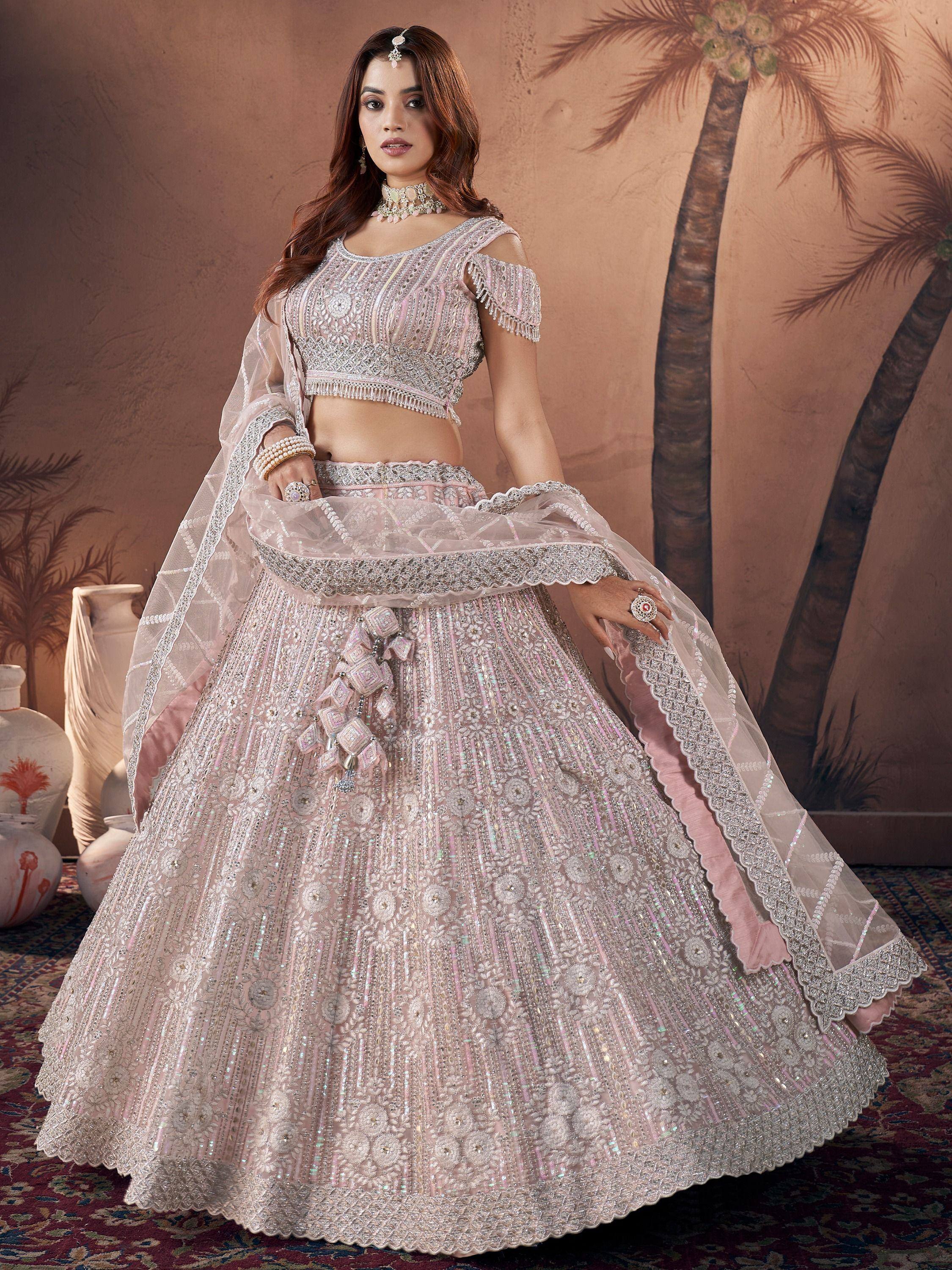 Elegant pink designer lehenga choli with intricate embroidery and sequins, perfect for weddings and festive occasions.