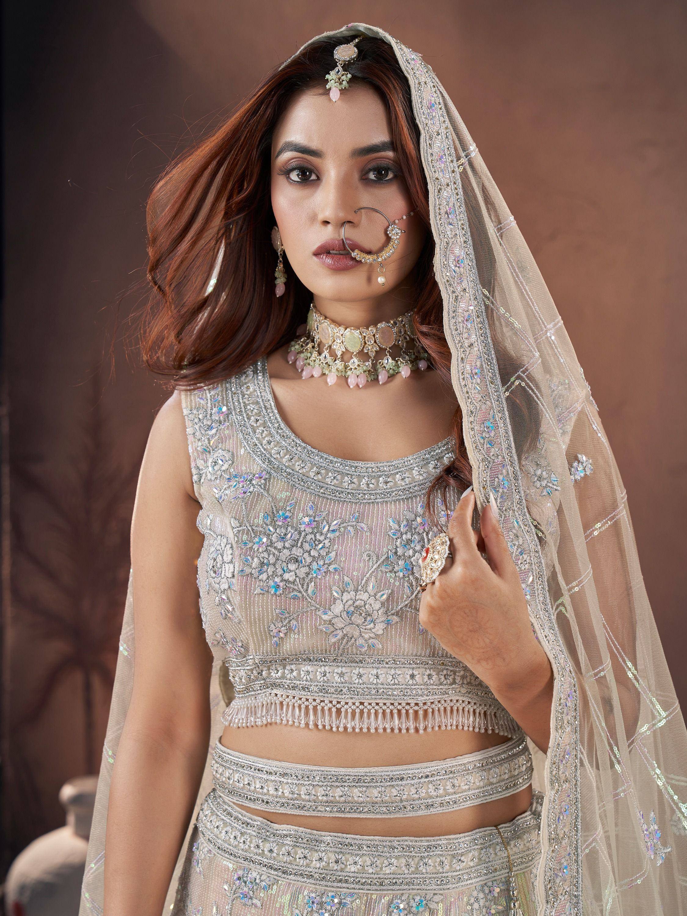 Elegant Indian bridal lehenga choli with intricate embroidery, sequins, and matching dupatta for wedding wear