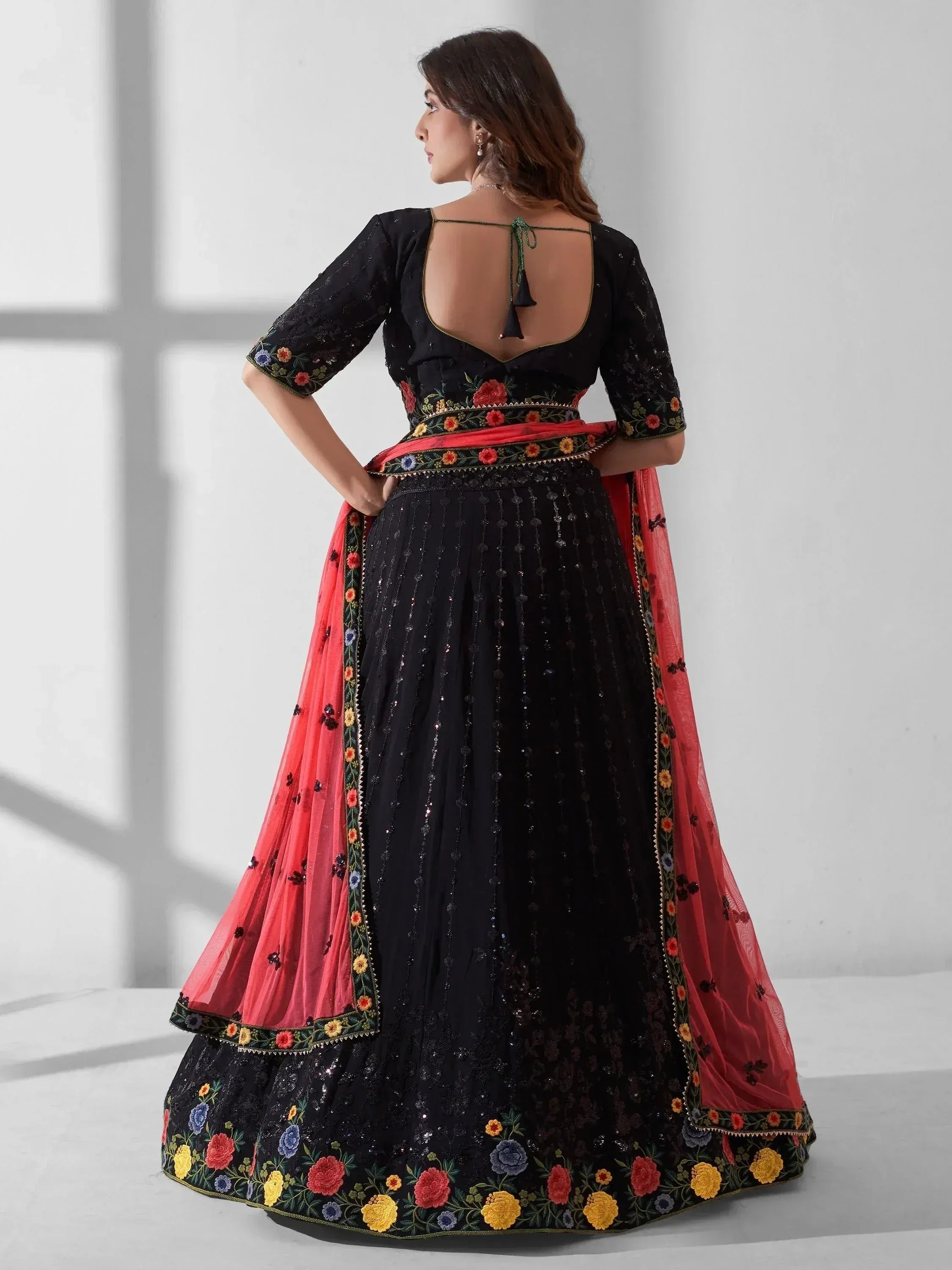 Black floral embroidered lehenga choli with open back and pink dupatta, Indian ethnic wear