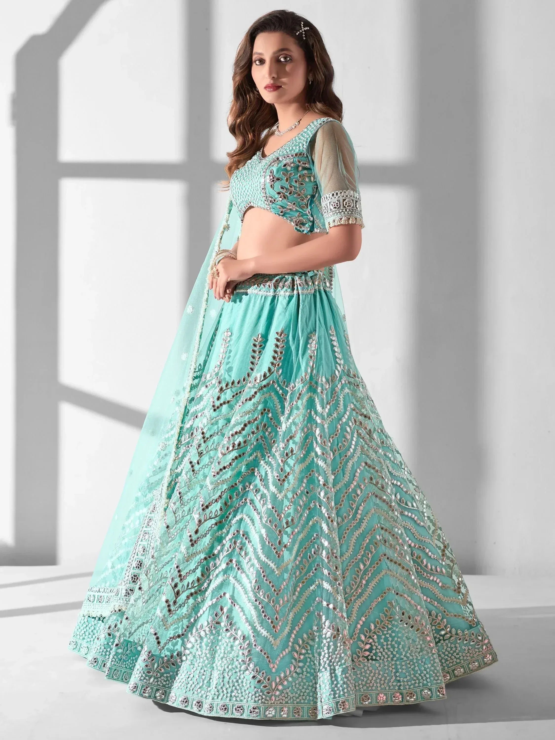 Mint green designer lehenga choli with intricate embroidery and sequin work for weddings and festivals