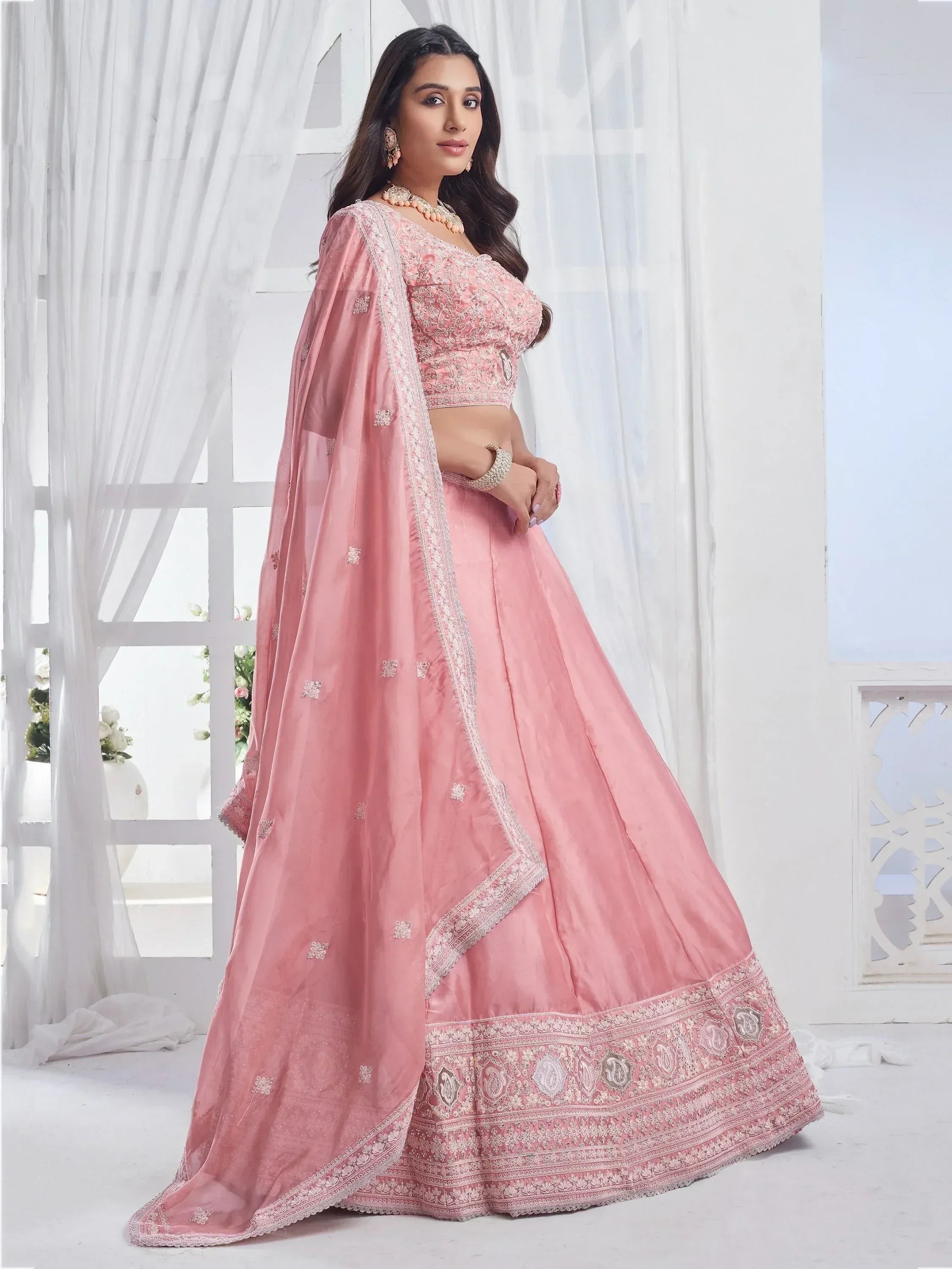 Pink designer lehenga choli with intricate embroidery and matching dupatta for Indian ethnic wear