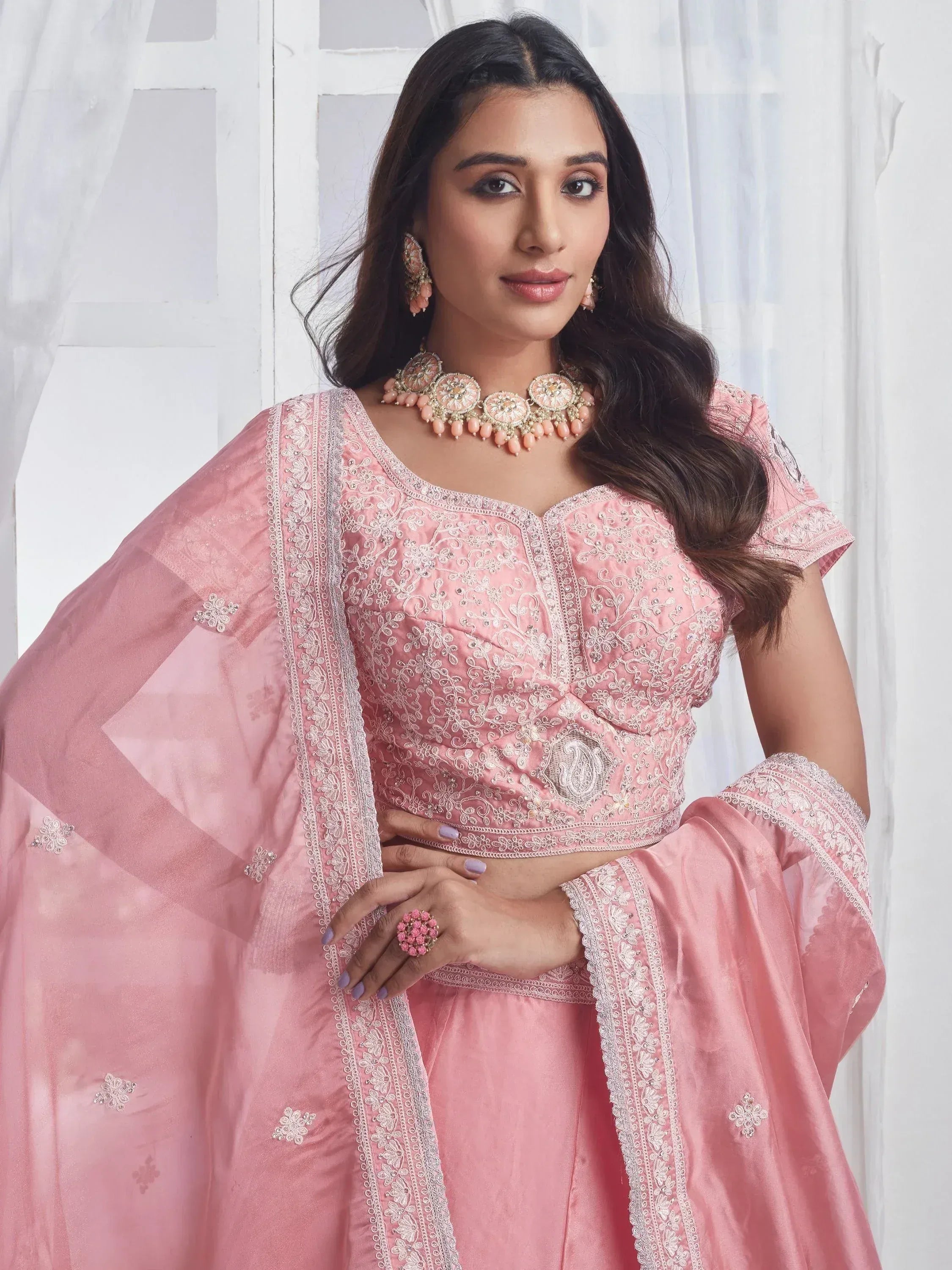Pink embroidered Indian ethnic wear with matching dupatta and jewelry for festive occasions