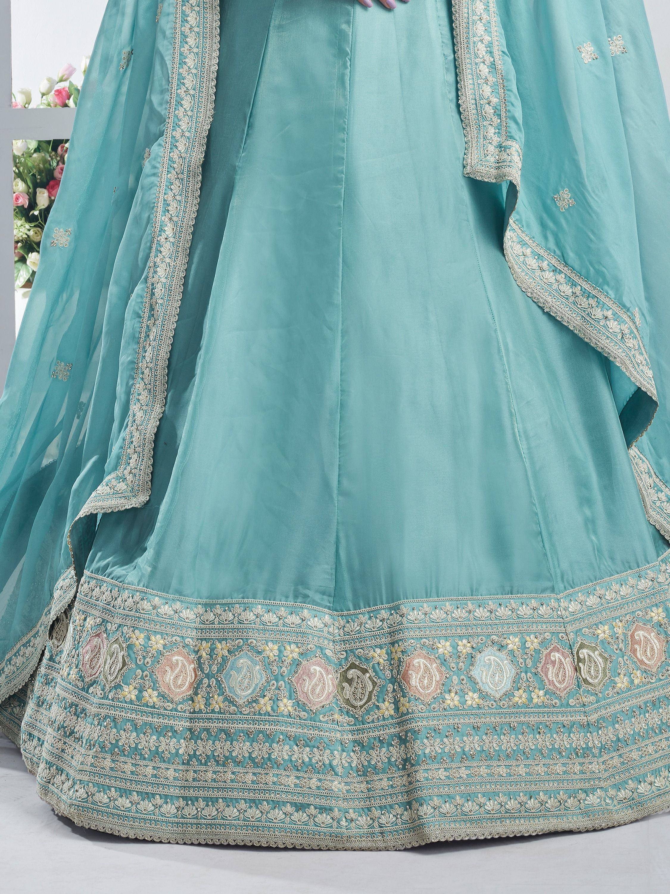 Turquoise designer lehenga with intricate embroidery and floral border details