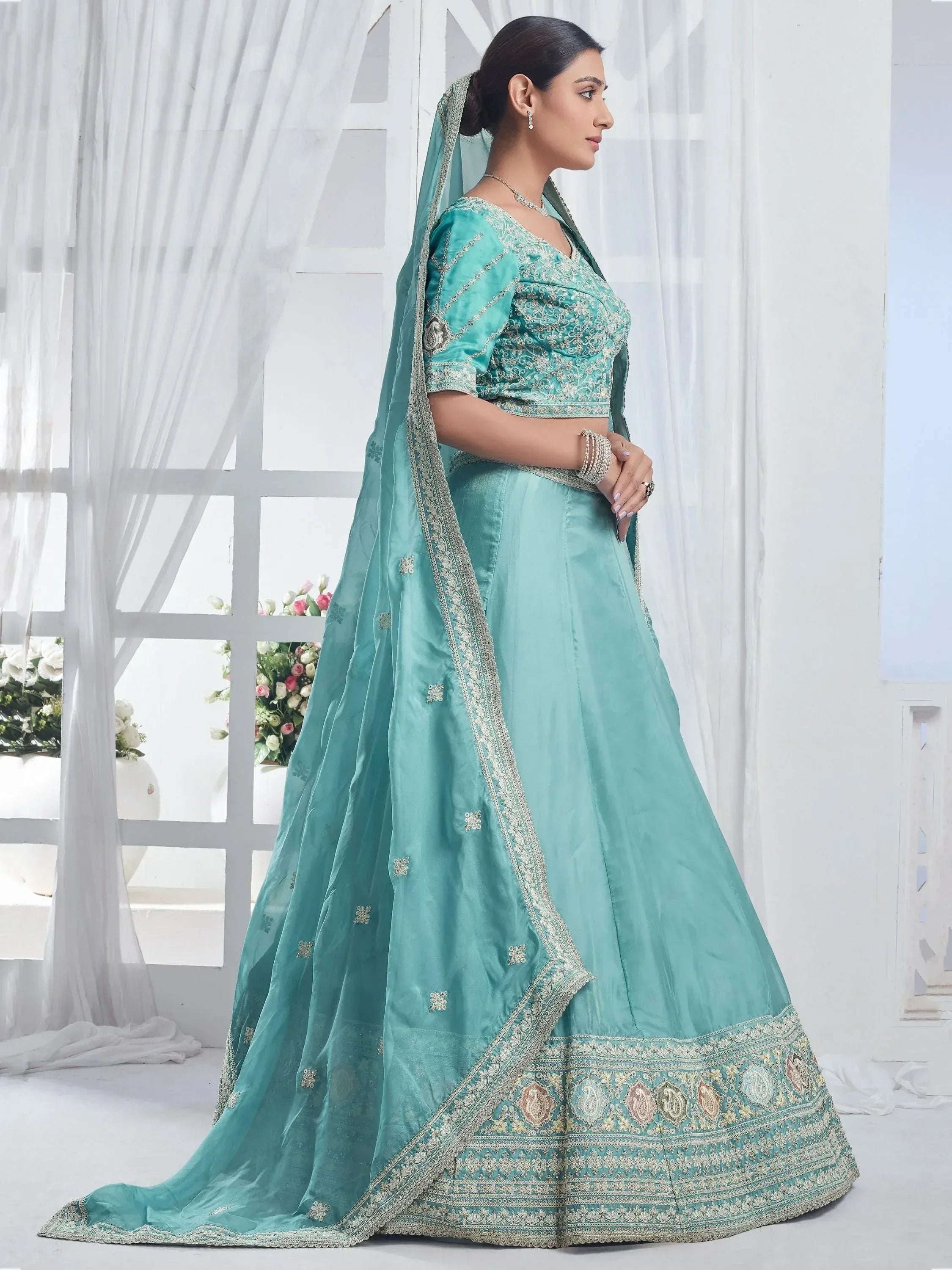 Mint green designer lehenga choli with intricate embroidery and matching dupatta for Indian ethnic wear