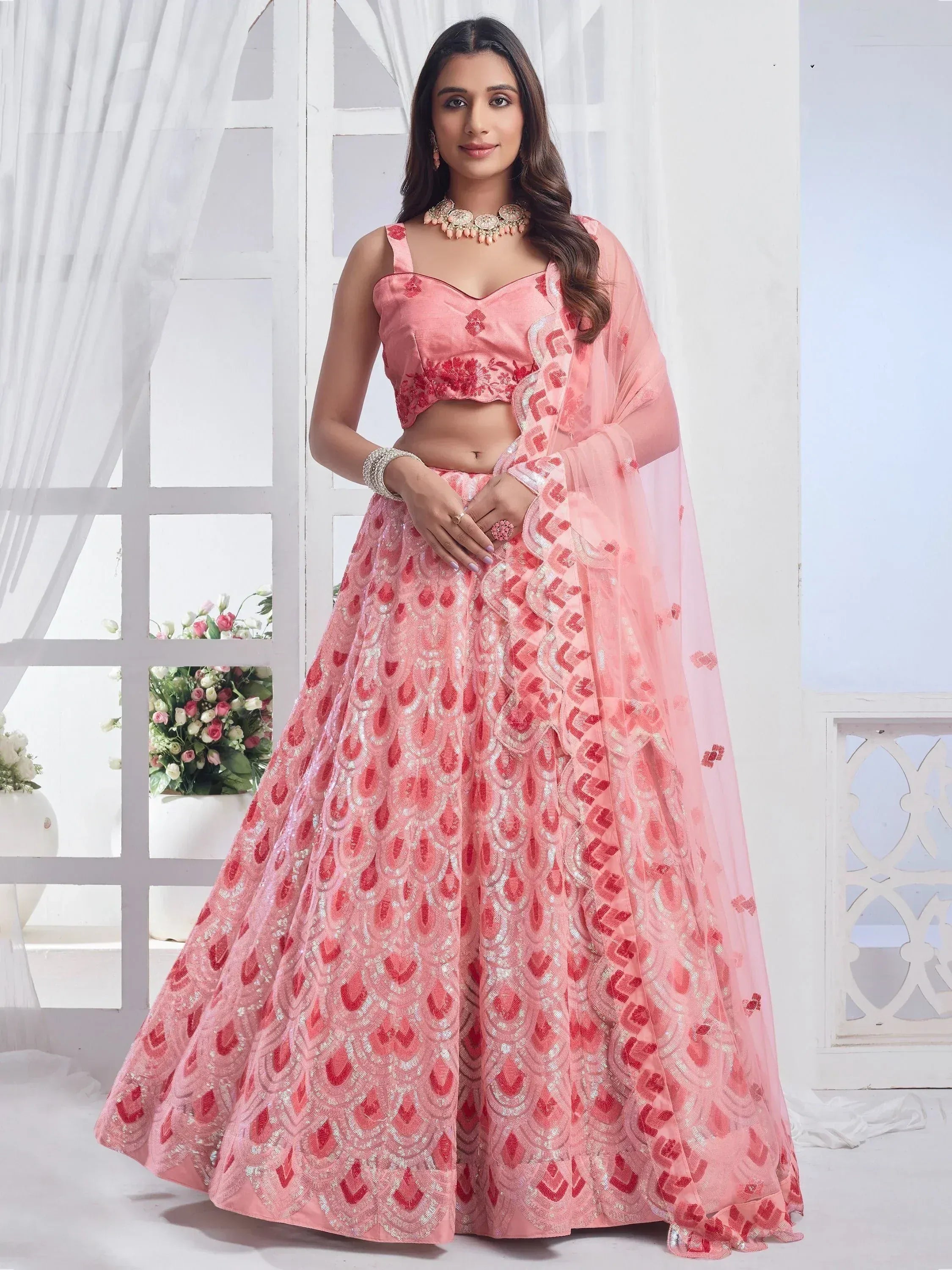Pink designer lehenga choli with intricate embroidery and sequin work, perfect for Indian ethnic occasions