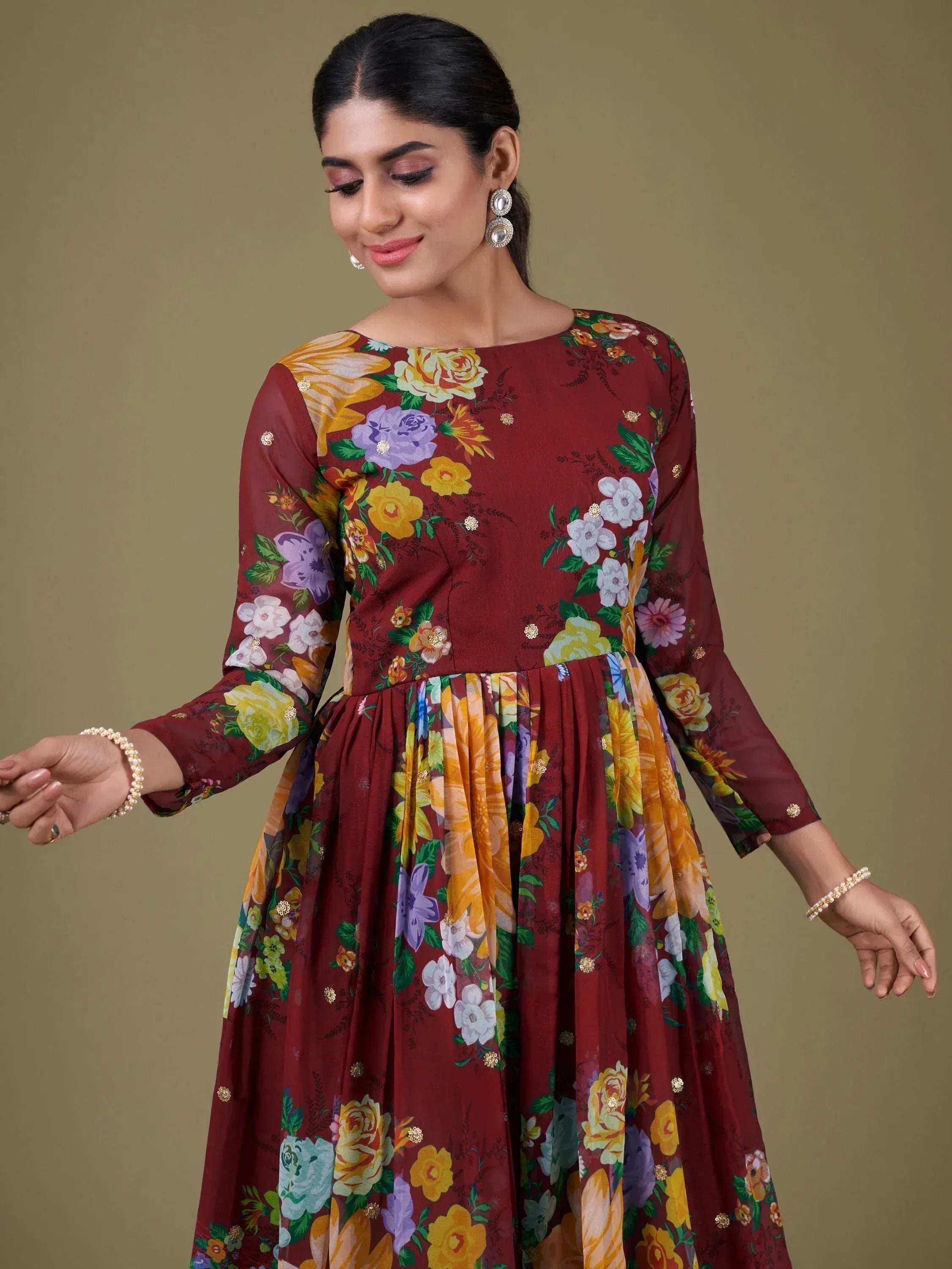 Maroon floral ethnic gown with long sleeves, perfect for Indian occasions and festive wear.