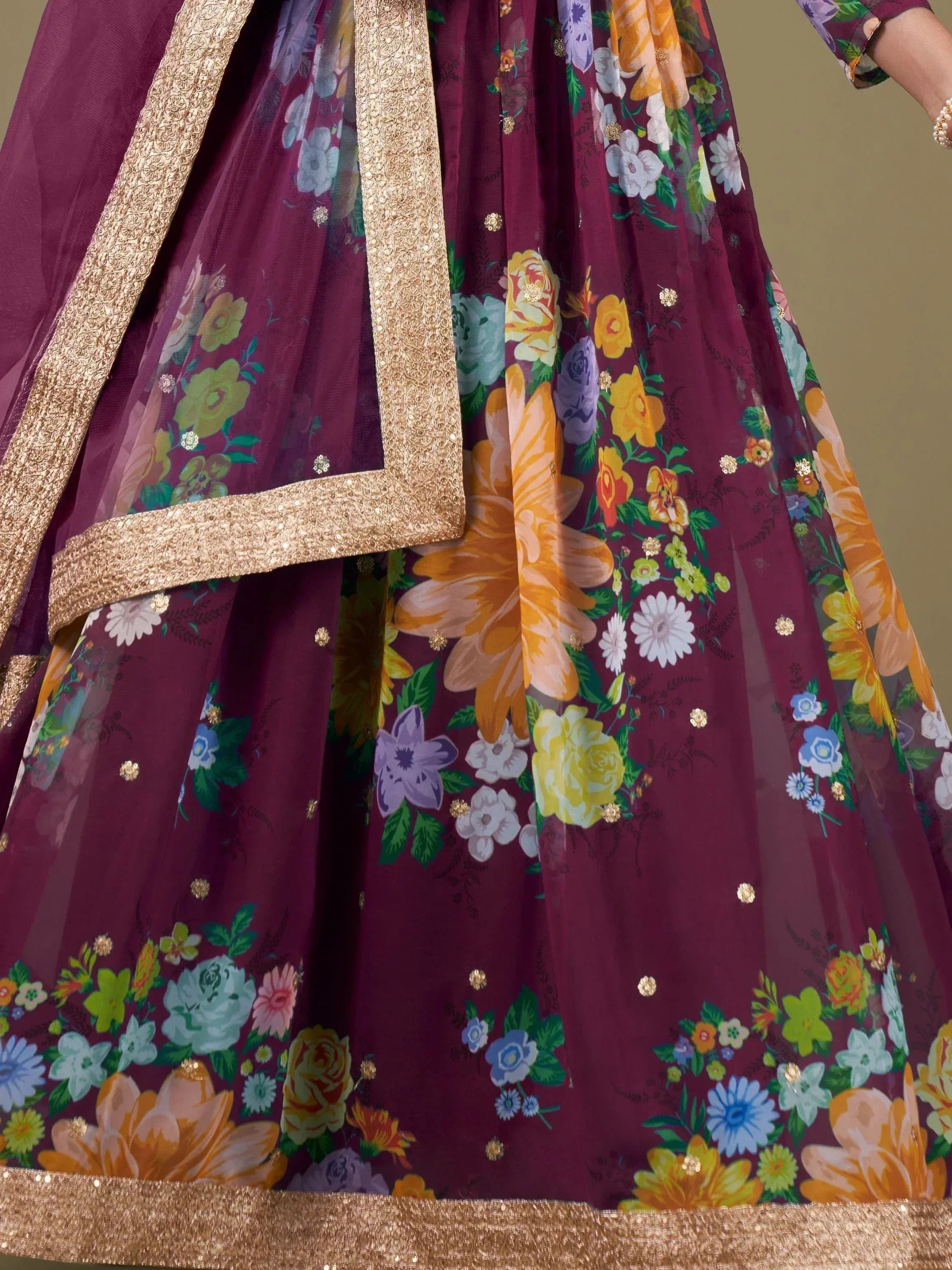 Vibrant floral print Indian lehenga with gold trim and sequin details, perfect for ethnic occasions.