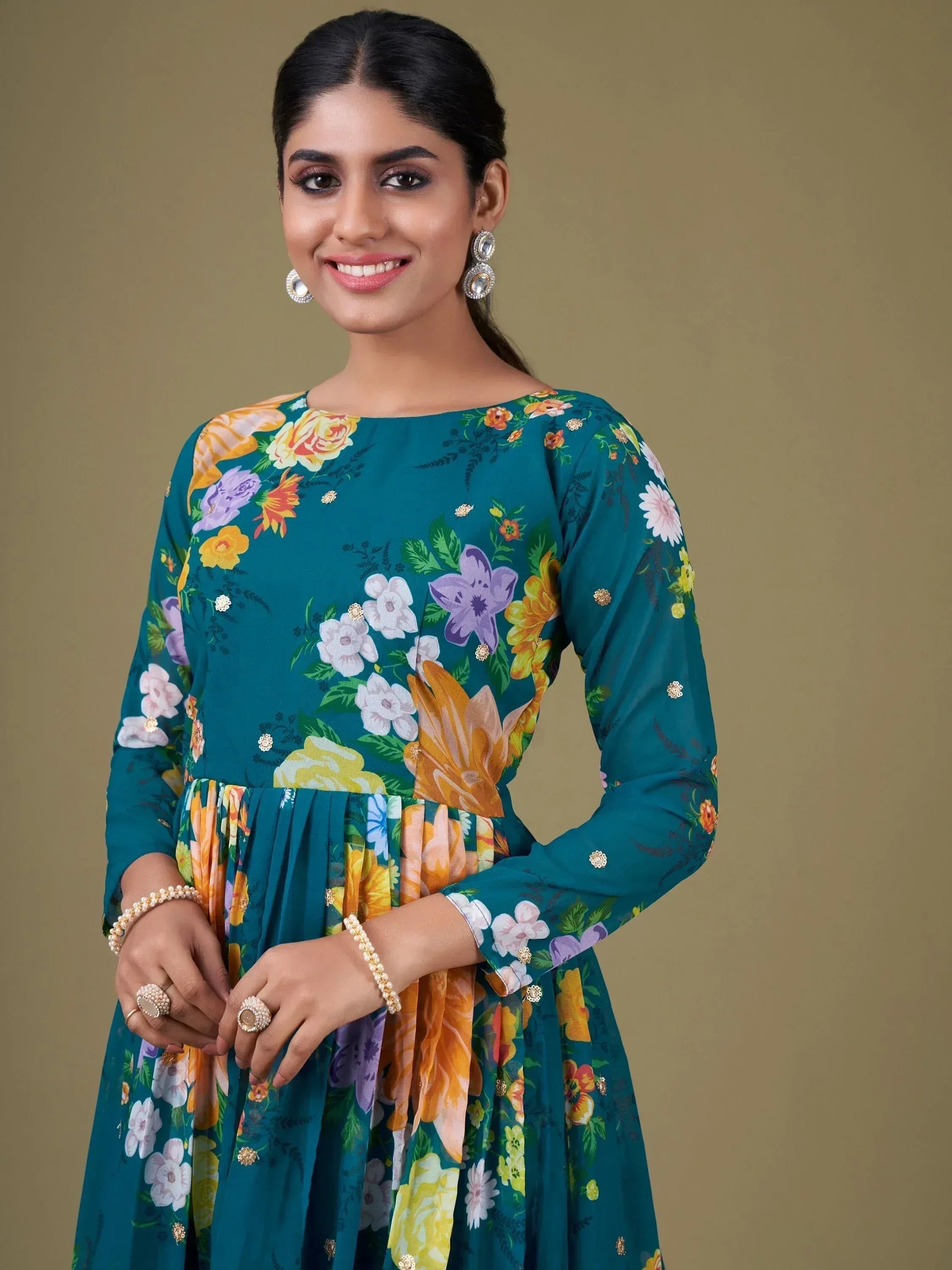 Teal floral ethnic gown with gold embroidery, perfect for Indian occasions and festive wear.