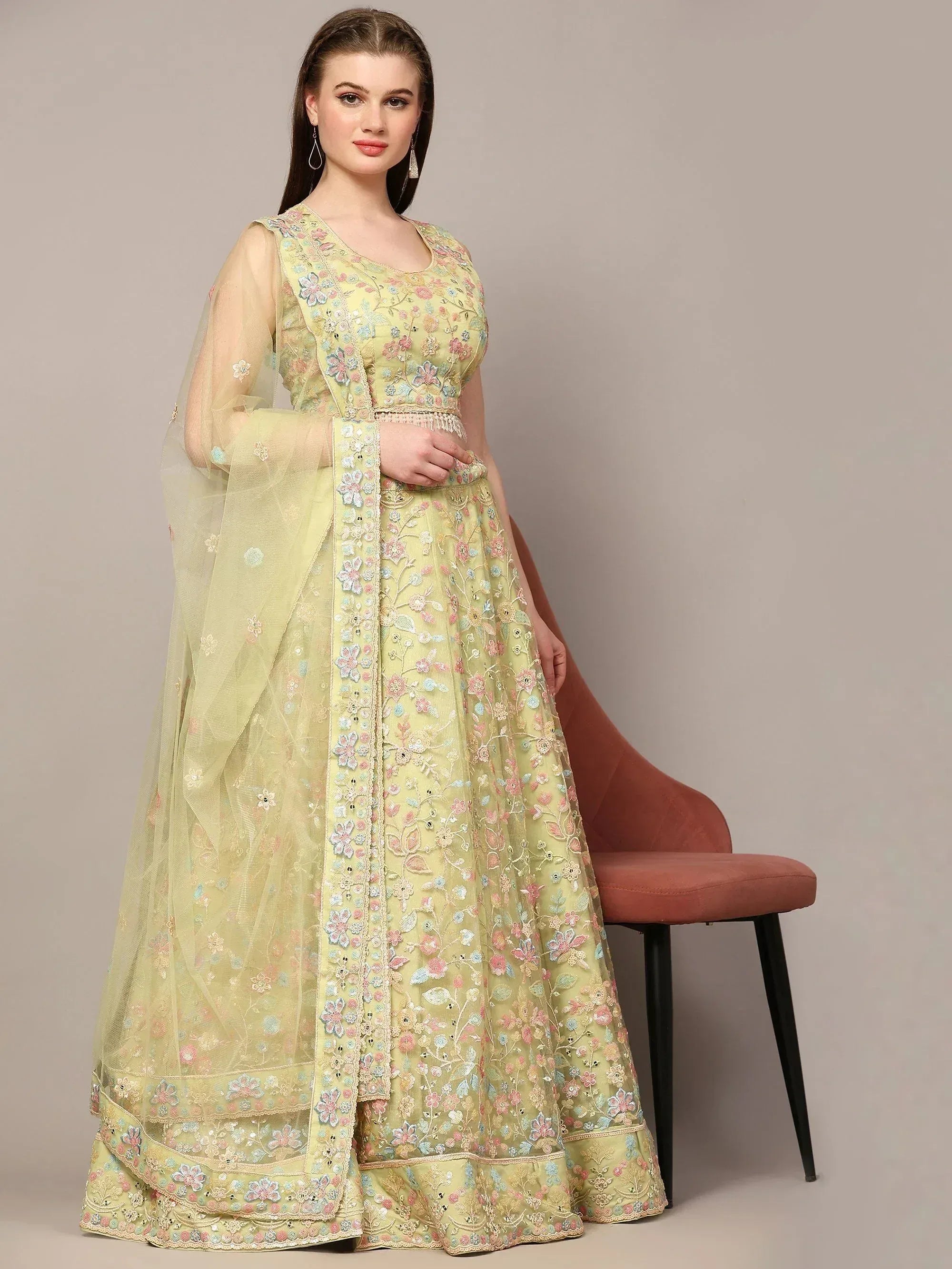 Light green embroidered lehenga choli with floral motifs and sheer dupatta, ideal for Indian ethnic occasions.