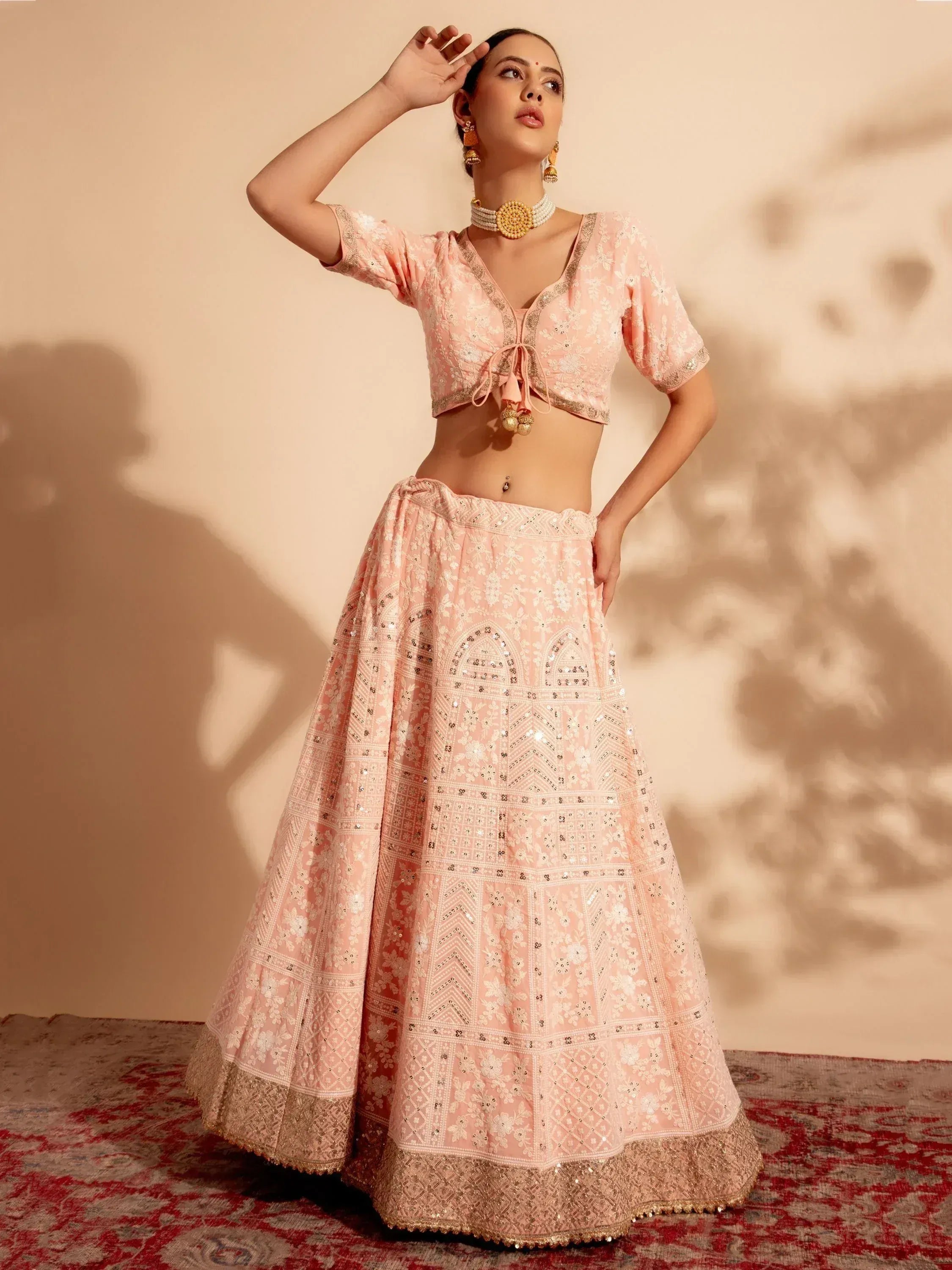 Pink embroidered lehenga choli with gold detailing, perfect for Indian ethnic wear and festive occasions