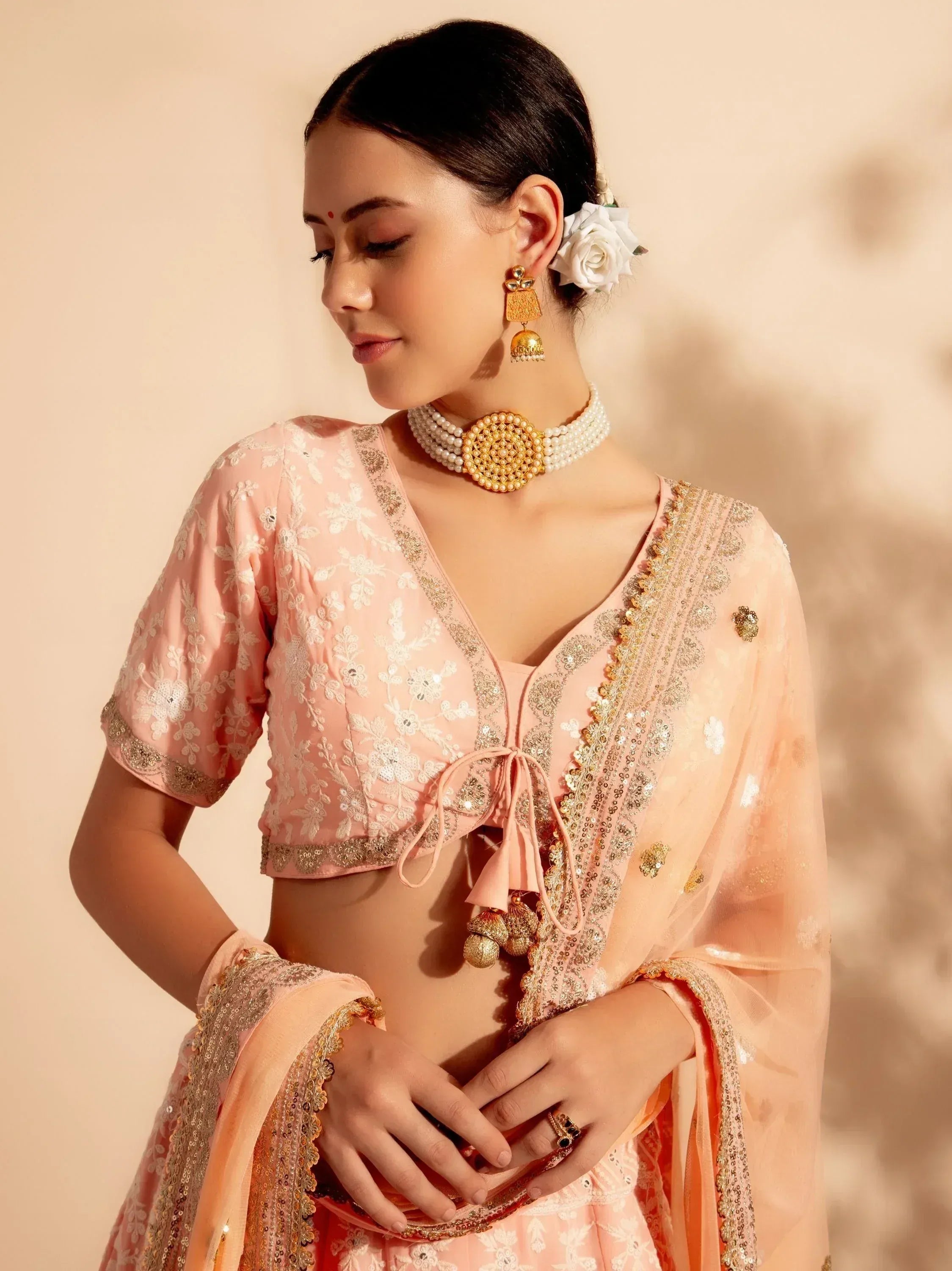 Pink embroidered lehenga choli with gold detailing, perfect for Indian ethnic wear and festive occasions.