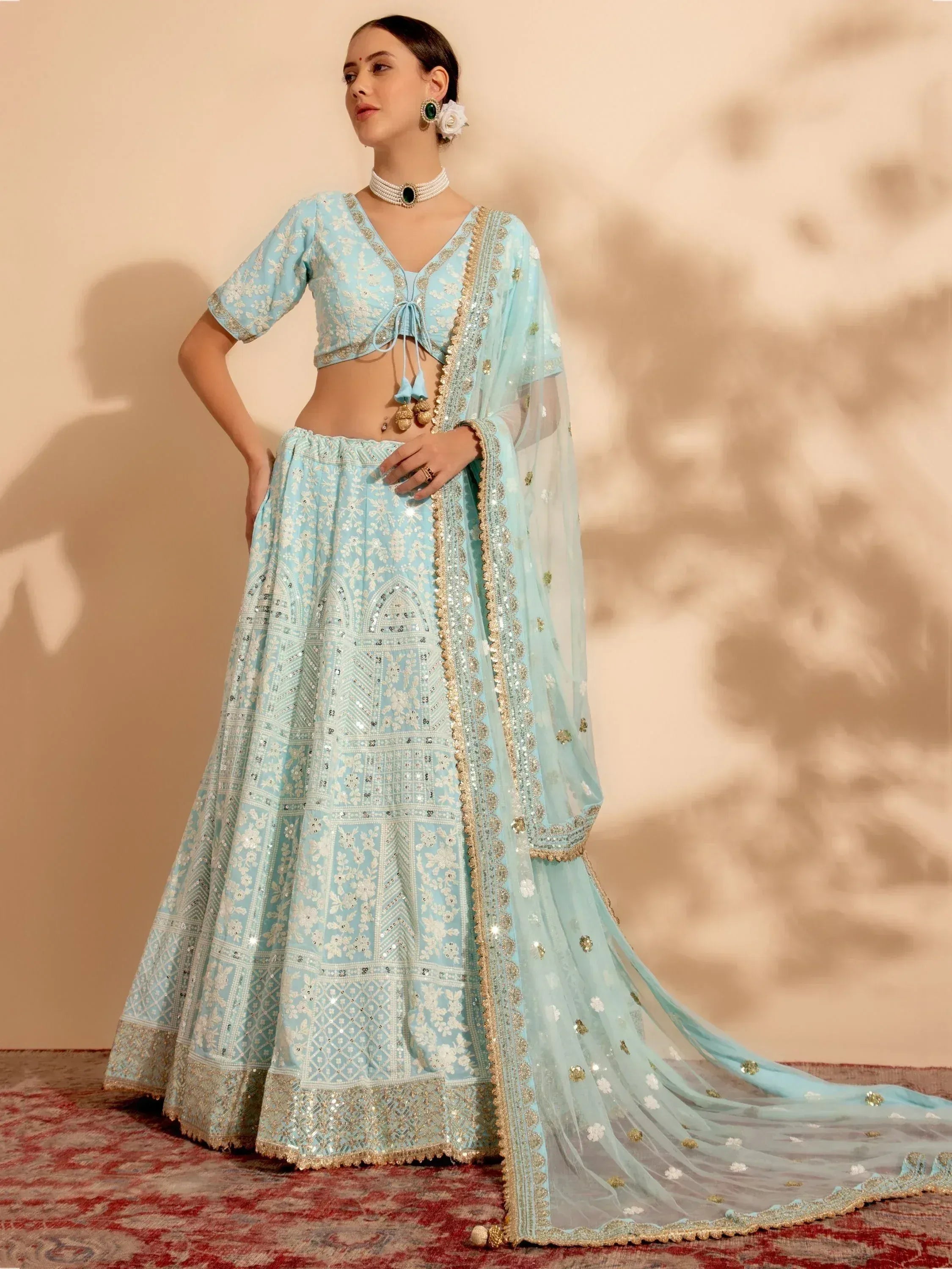 Light blue embroidered lehenga choli with gold detailing, perfect for Indian ethnic wear and festive occasions.