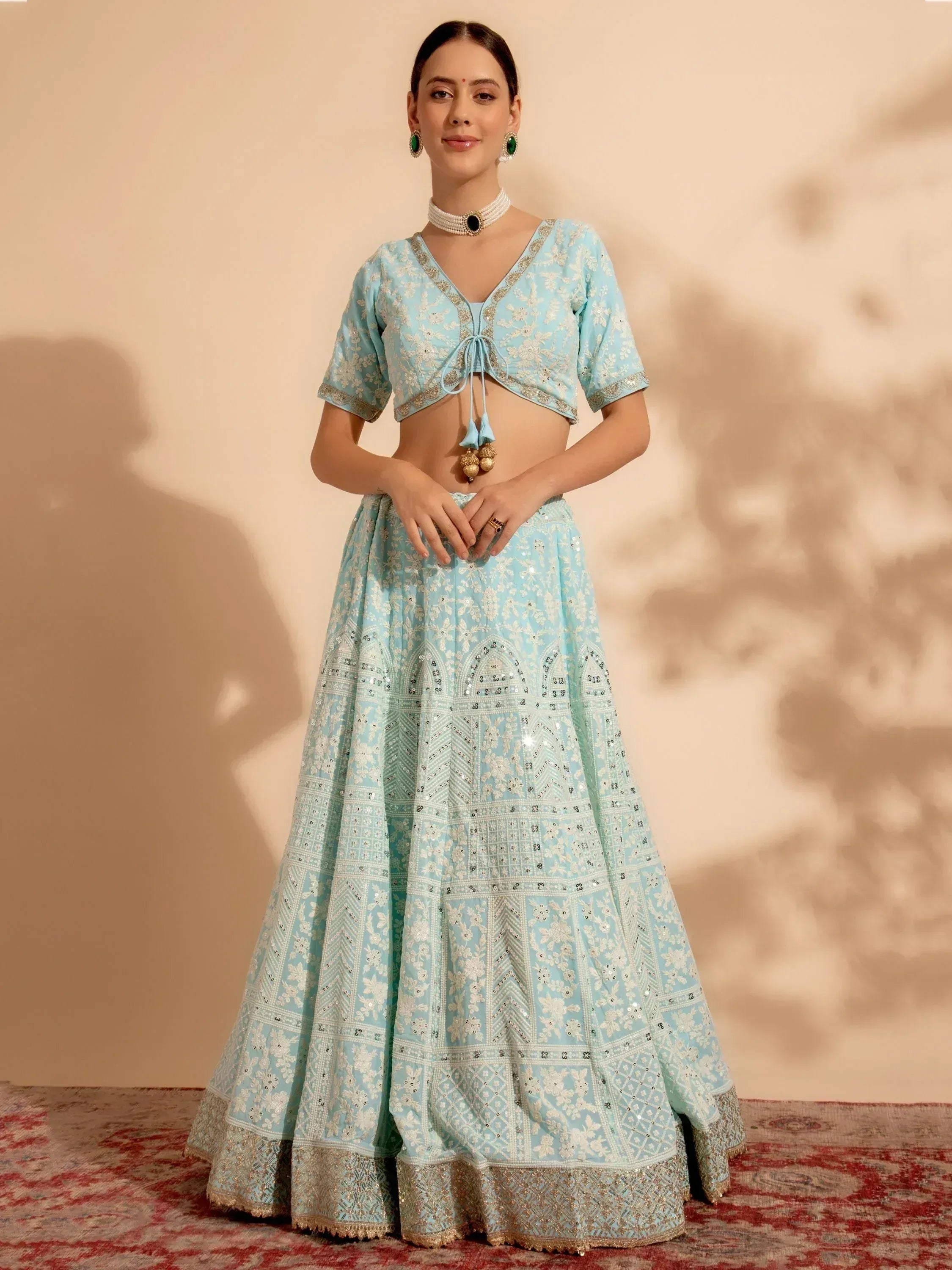 Light blue embroidered lehenga choli with gold detailing, perfect for Indian ethnic wear occasions.