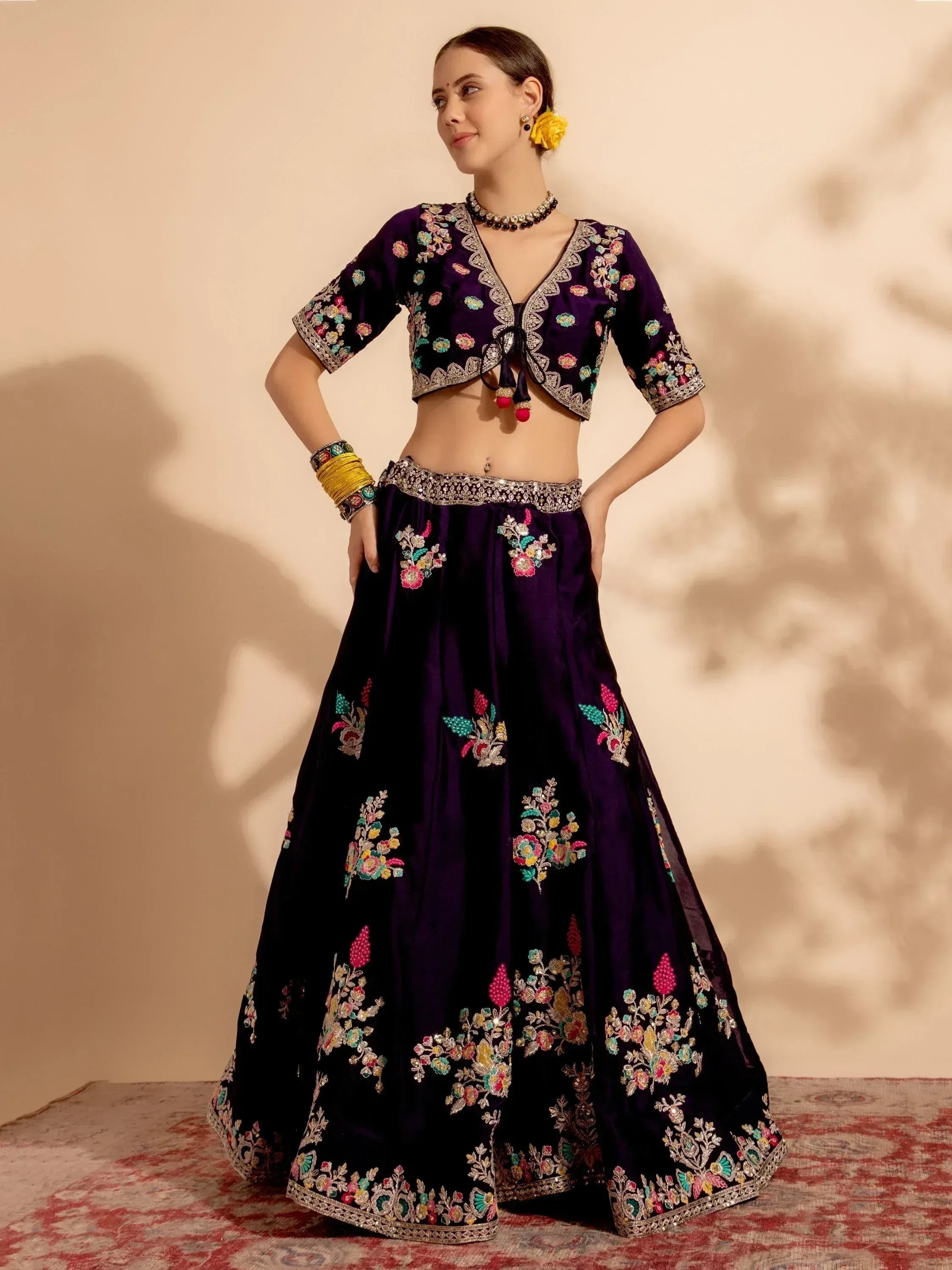 Purple embroidered lehenga choli with floral motifs, perfect for Indian ethnic wear occasions.