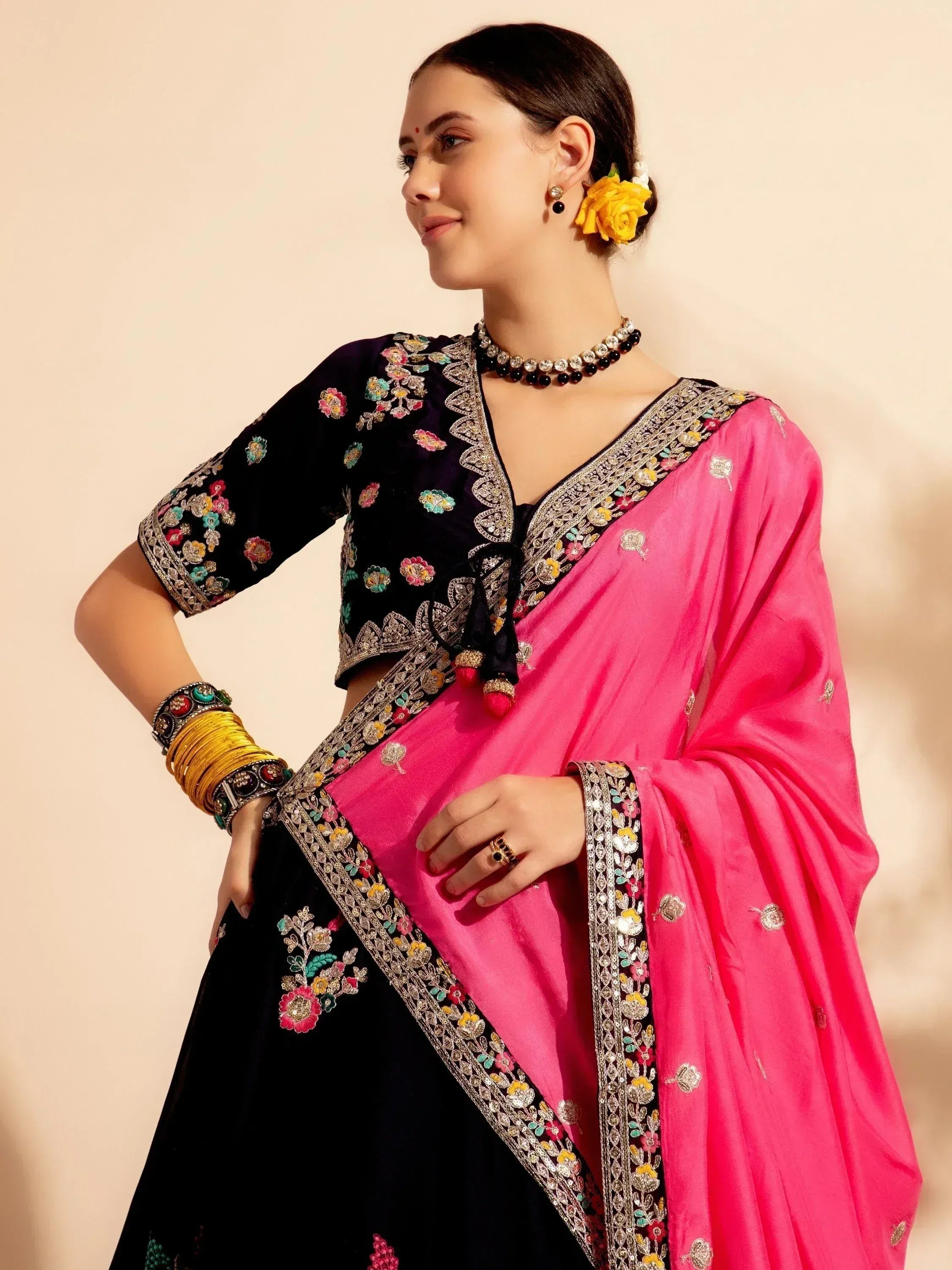 Black and pink embroidered ethnic saree with floral motifs, perfect for Indian celebrations and festive occasions.