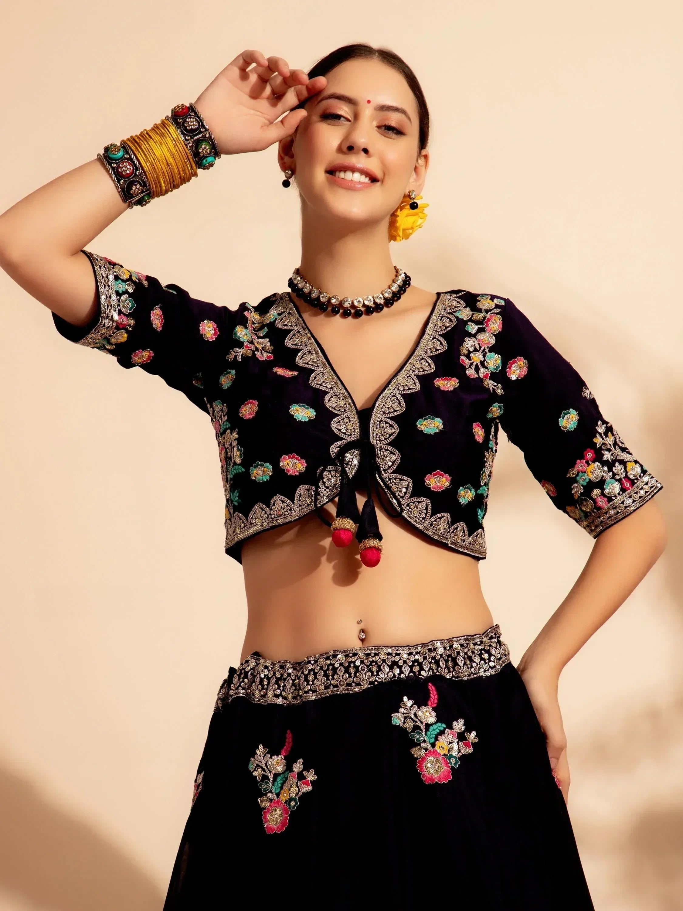 Black embroidered lehenga choli with floral motifs, perfect for Indian ethnic wear and festive occasions.